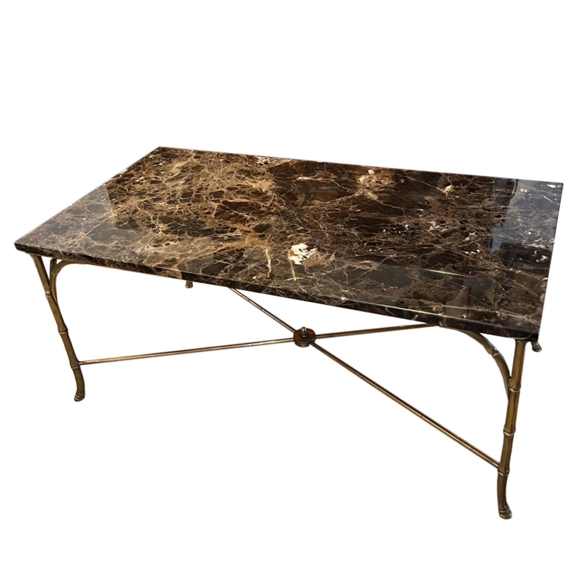 This is a lovely 1960s coffee table. The beautiful marble top is supported by a brass faux bamboo frame.

Elegant, mid century design.

Made in France.