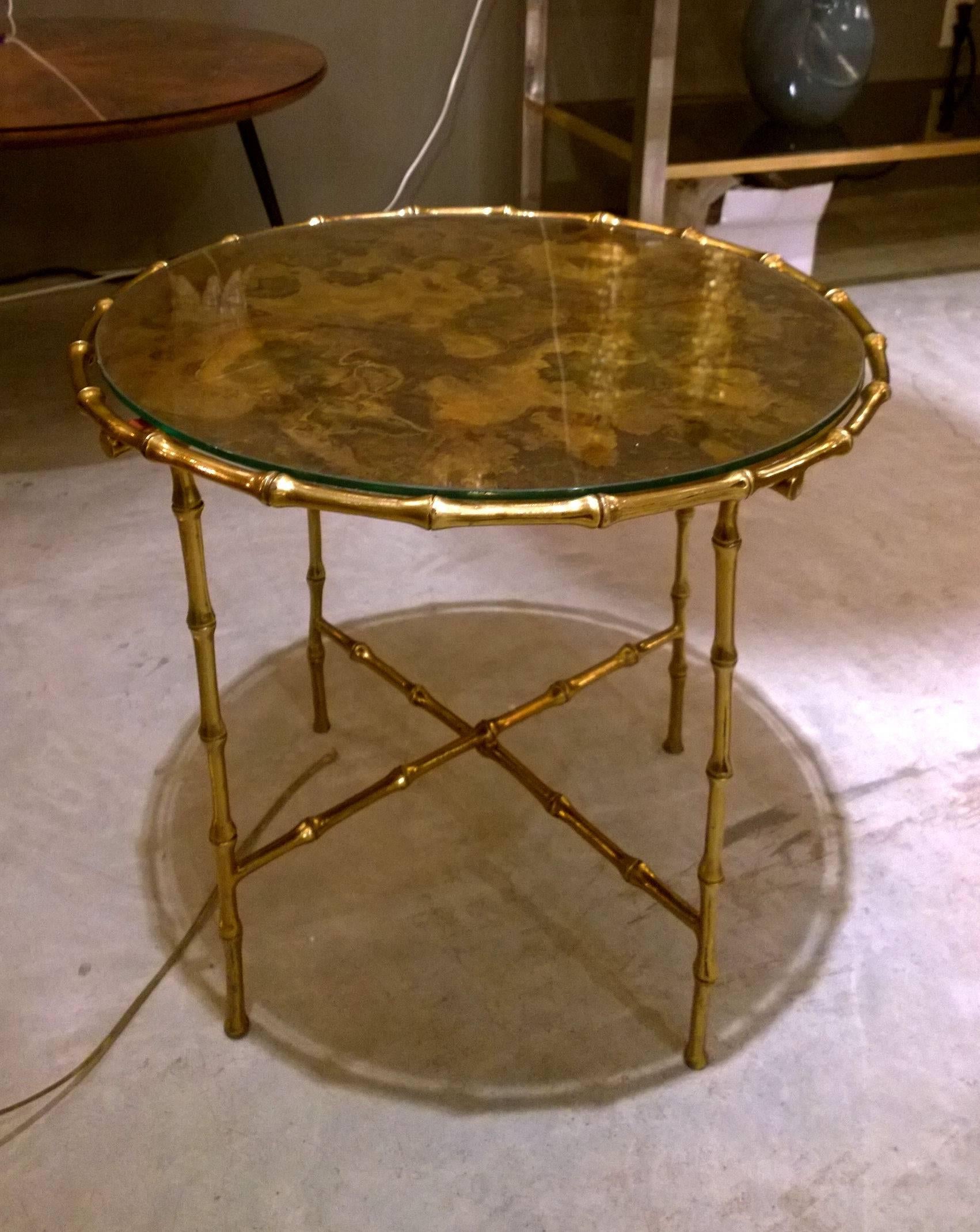 Mid-Century Modern French faux bamboo coffee table in brass. The round tabletop is acid treated brass covered by transparent glass.