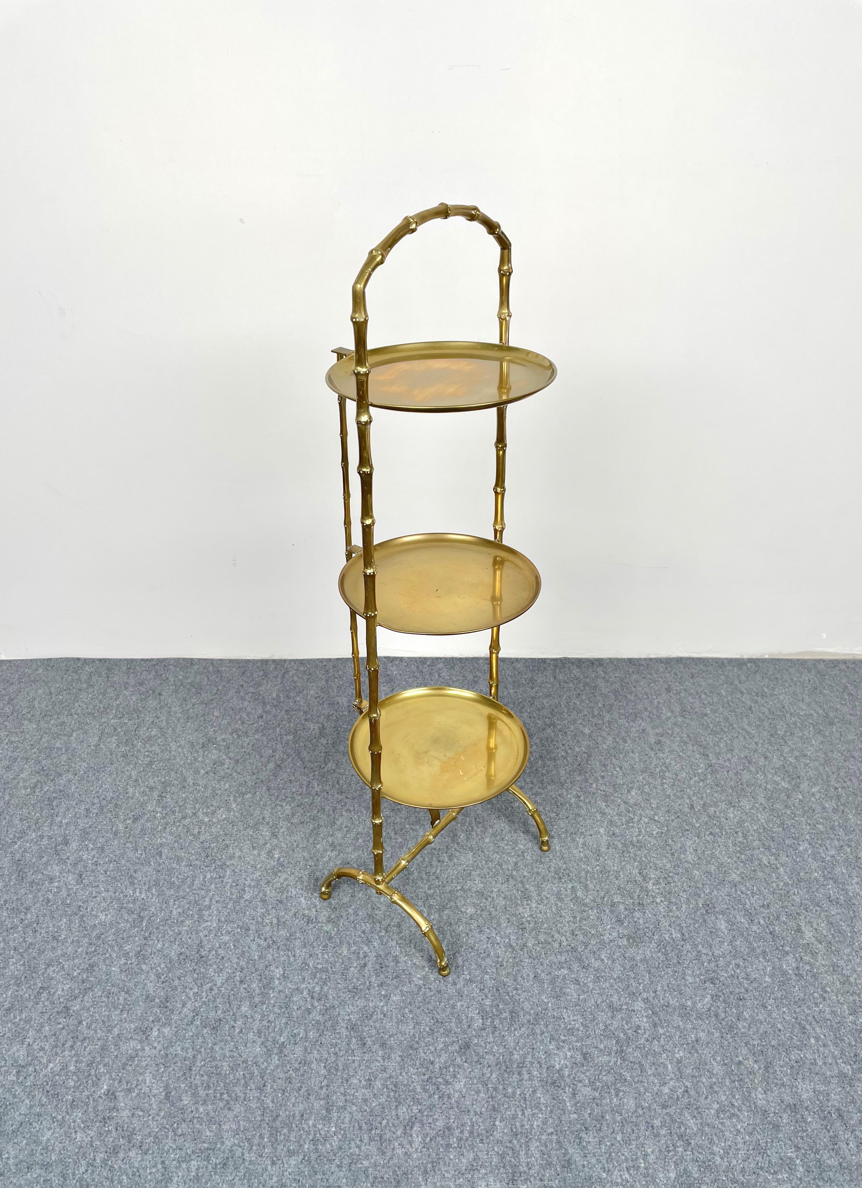 Foldable serving tray table consisting of three shelves in brass with a faux bamboo brass structure by Maison Baguès, France, 1950s.