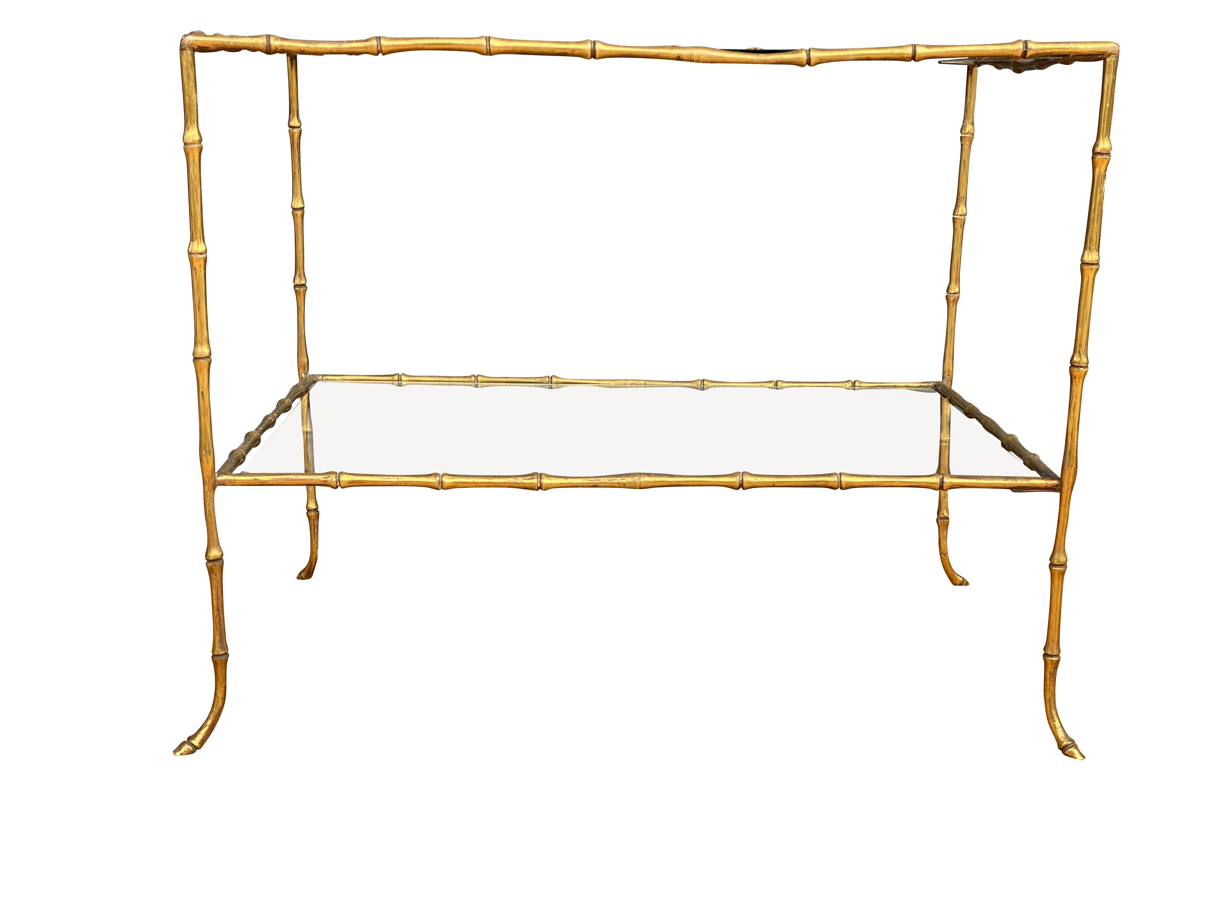 Rectangular with clear glass insert with conforming lower tier, curved conforming feet. Provenance; William Hodgins Inc. Boston.