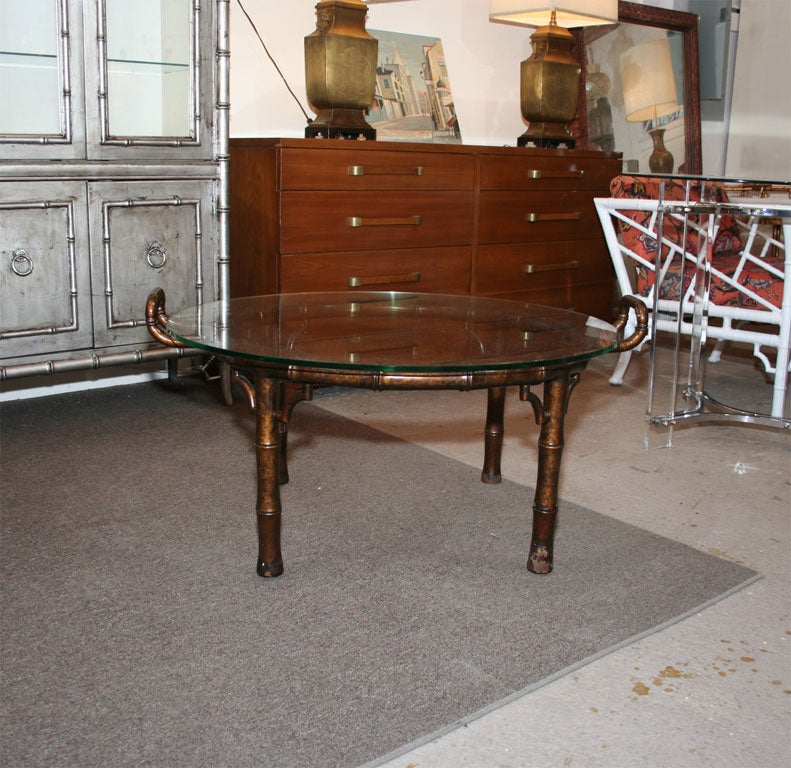 Wood faux bamboo coffee table, looks like a large butler tray. Tortoise shell finish. Note finish loss and scratches to glass.