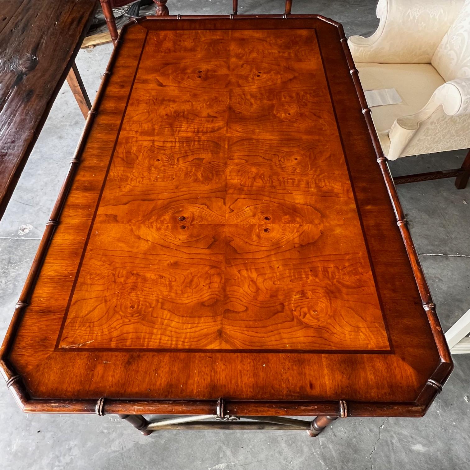 Ernest Hemingway style beautifully made desk or writing table with chinoiserie faux bamboo, burl wood inlay, finished back, and drawers (one opens for a keyboard)  The desk features a crotch flame mahogany veneer top with banded inlay border and