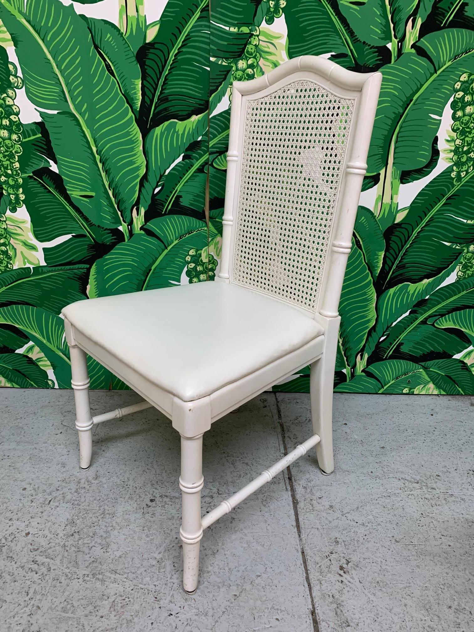 Set of six vintage Thomasville dining chairs feature cane backs and faux bamboo detailing. Very good condition with minor imperfections consistent with age.