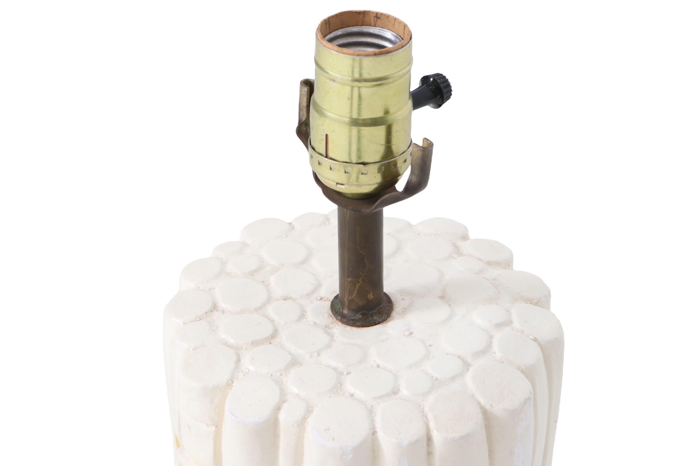 A coastal style ceramic table lamp pressed to give the look of bamboo. Detailed with yellow leaves around the body and circles on top to indicate multiple canes.
 
