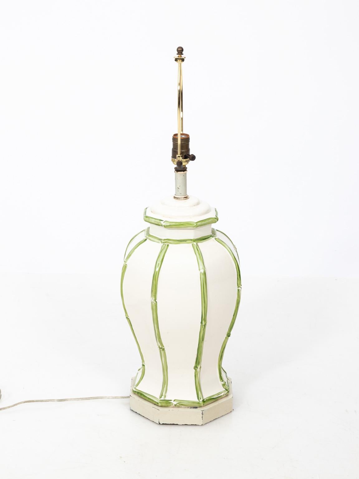 Hollywood Regency style, faux bamboo ceramic table lamp with green painted faux-bamboo trim circa 1970s. Please note of wear consistent with age including paint loss on the base. Made in the United States. Shade not included.
