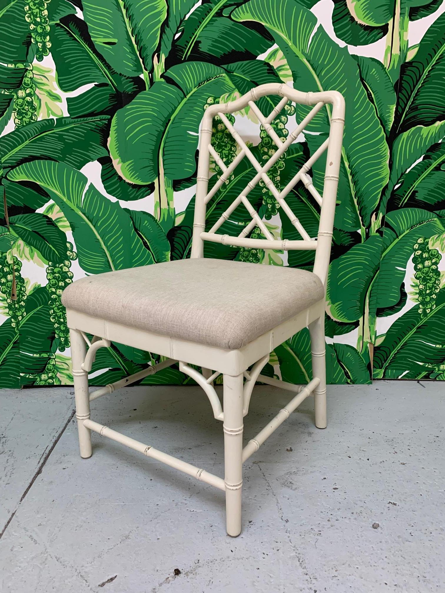 Set of 6 dining chairs in chinoiserie style with Chinese Chippendale style fretwork. Chairs are upholstered in a neutral fabric. All chairs are structurally sound. There is some staining on fabric.