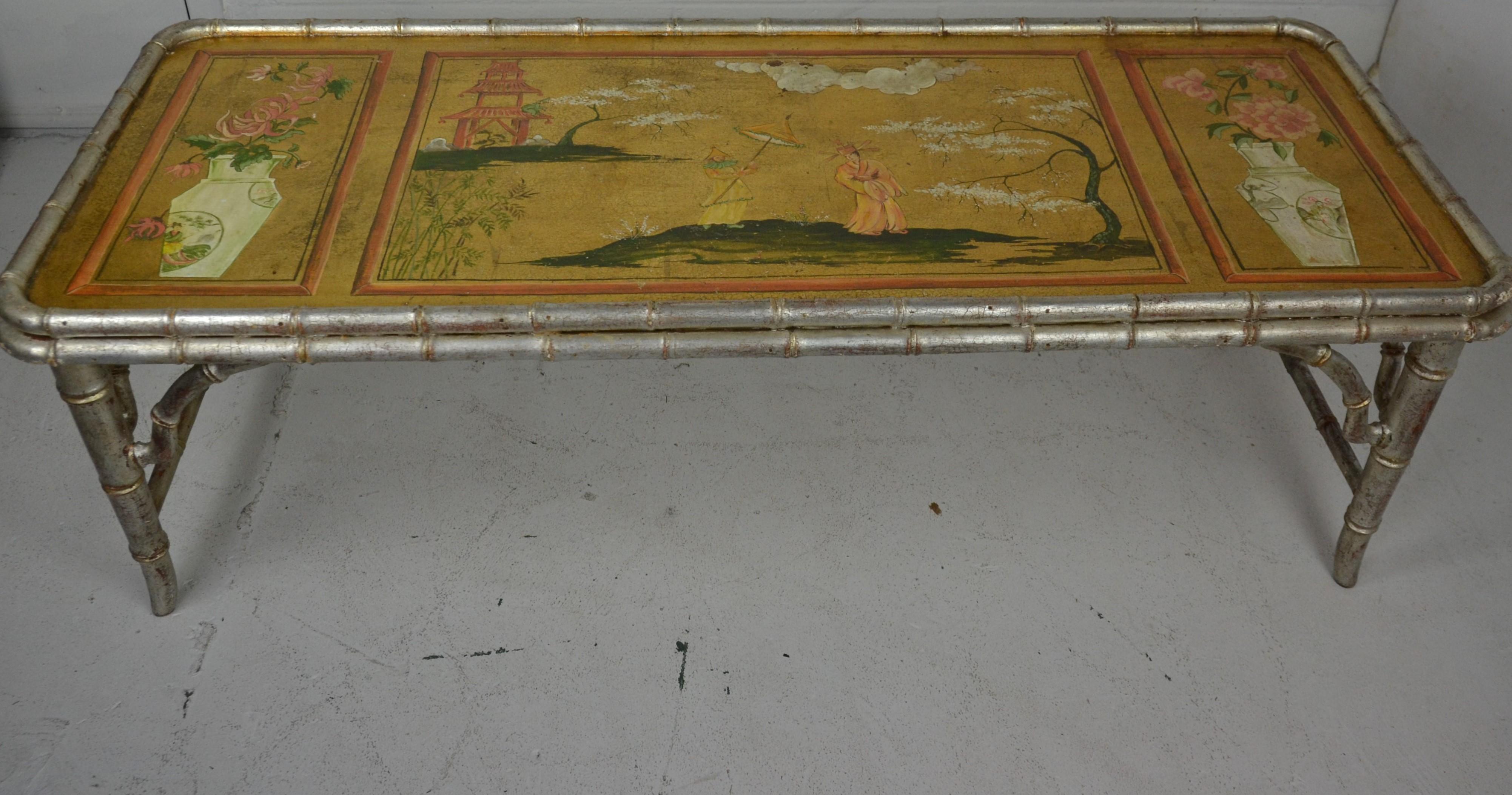 A 1950s-1960s faux bamboo coffee table in a silvered finish. Chinoiserie top decorated in 3 panels. Italian made.