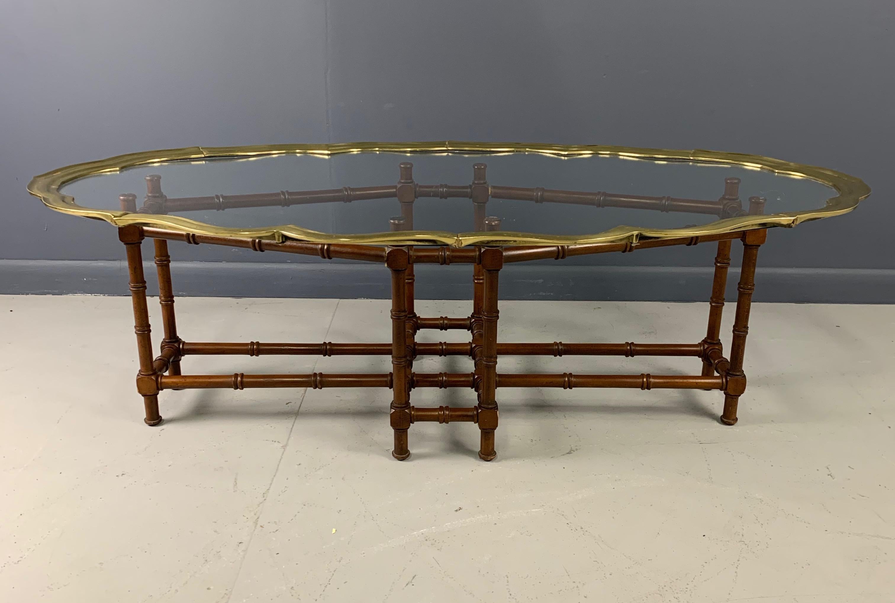 Vintage faux bamboo coffee/cocktail table features metal frame and glass tray top rimmed in solid brass. Good vintage condition with minor imperfections consistent with age.