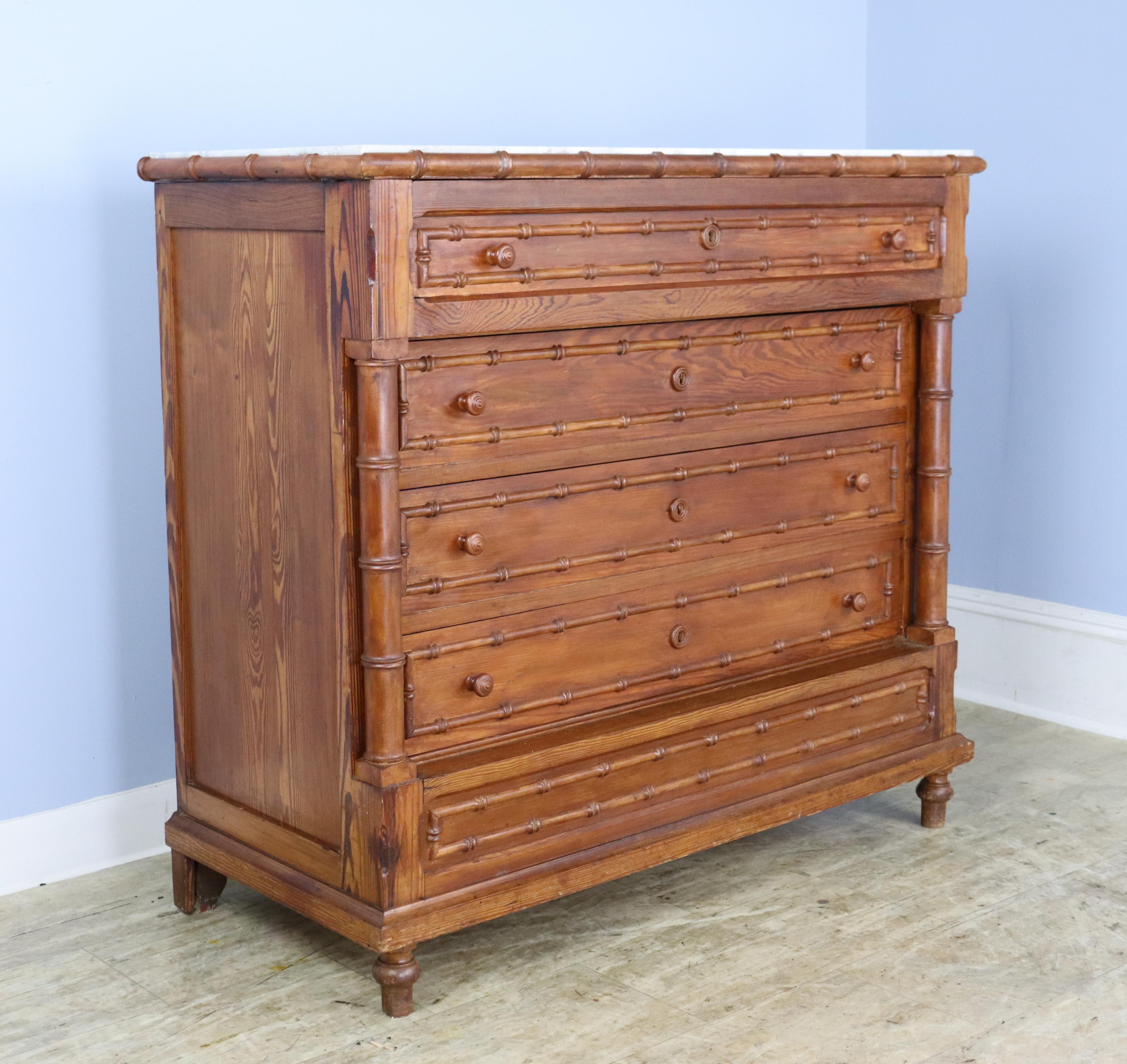 A very good looking antique faux bamboo chest of drawers with lots of bamboo trim and mouldings.  Also notable are the columns on either side which add another level of interest.  Marble is in good condition, with some areas of wear and