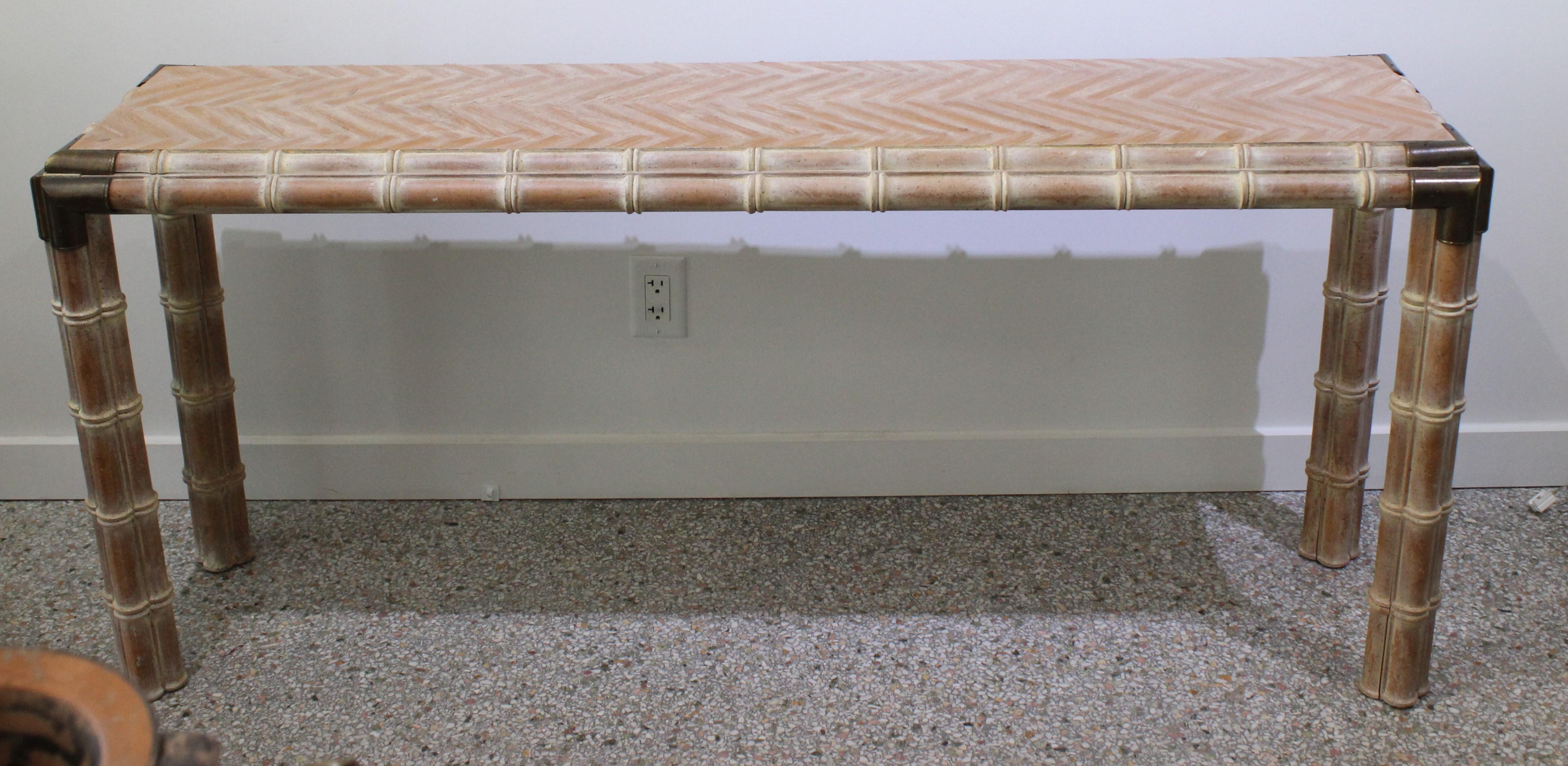 This stylish 1970s faux bamboo console has a pickeled finish with a white/yellowish coloration. 

 