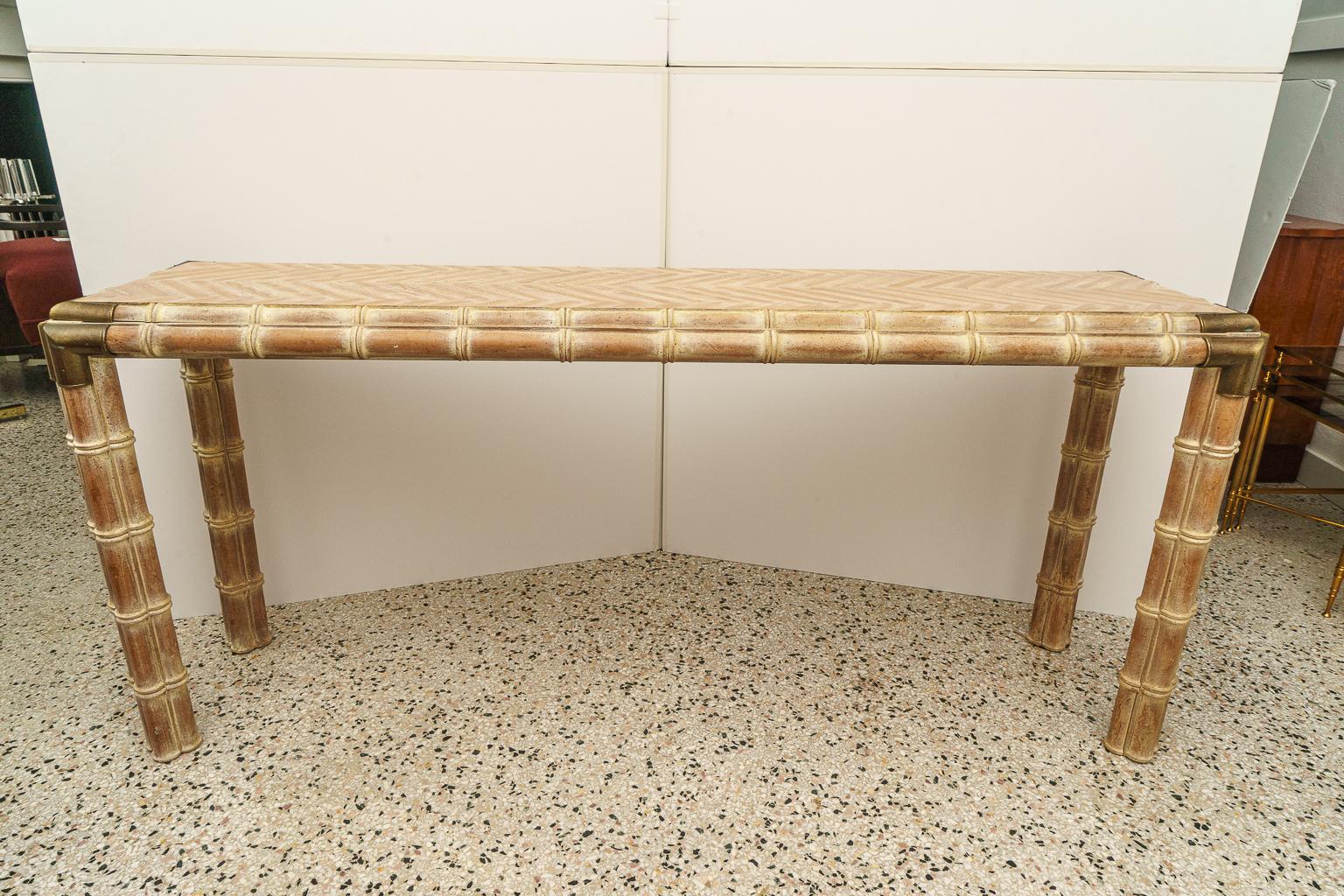 Handsome console table, faux bamboo with antique brass mounts.

  