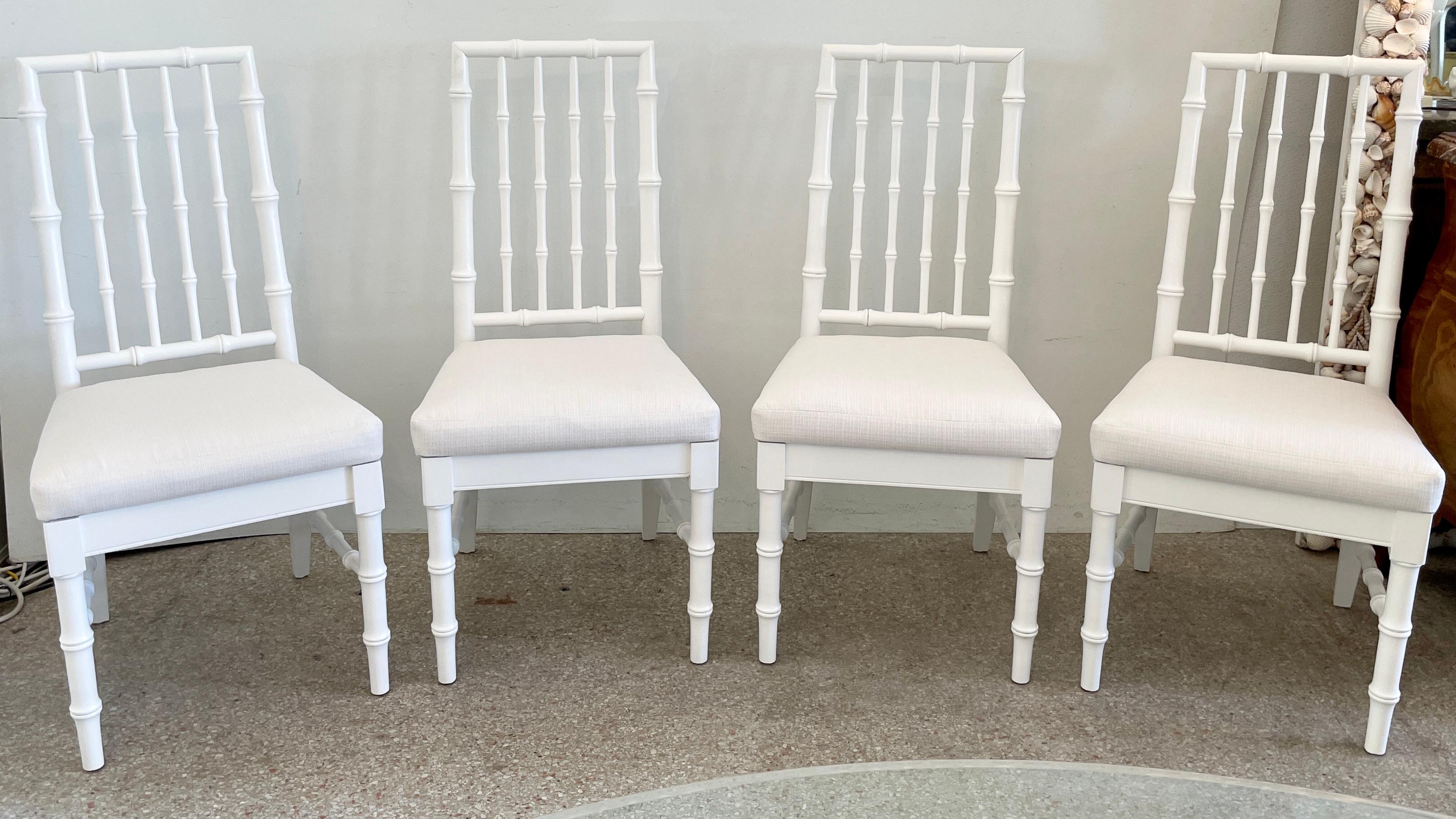 Fabulous set of four faux bamboo dining chairs in white lacquer and Todd Hase High Performance textiles. New cushions added and they make a great addition to your boho chic interiors. We have several matching dining tables and other chairs that go