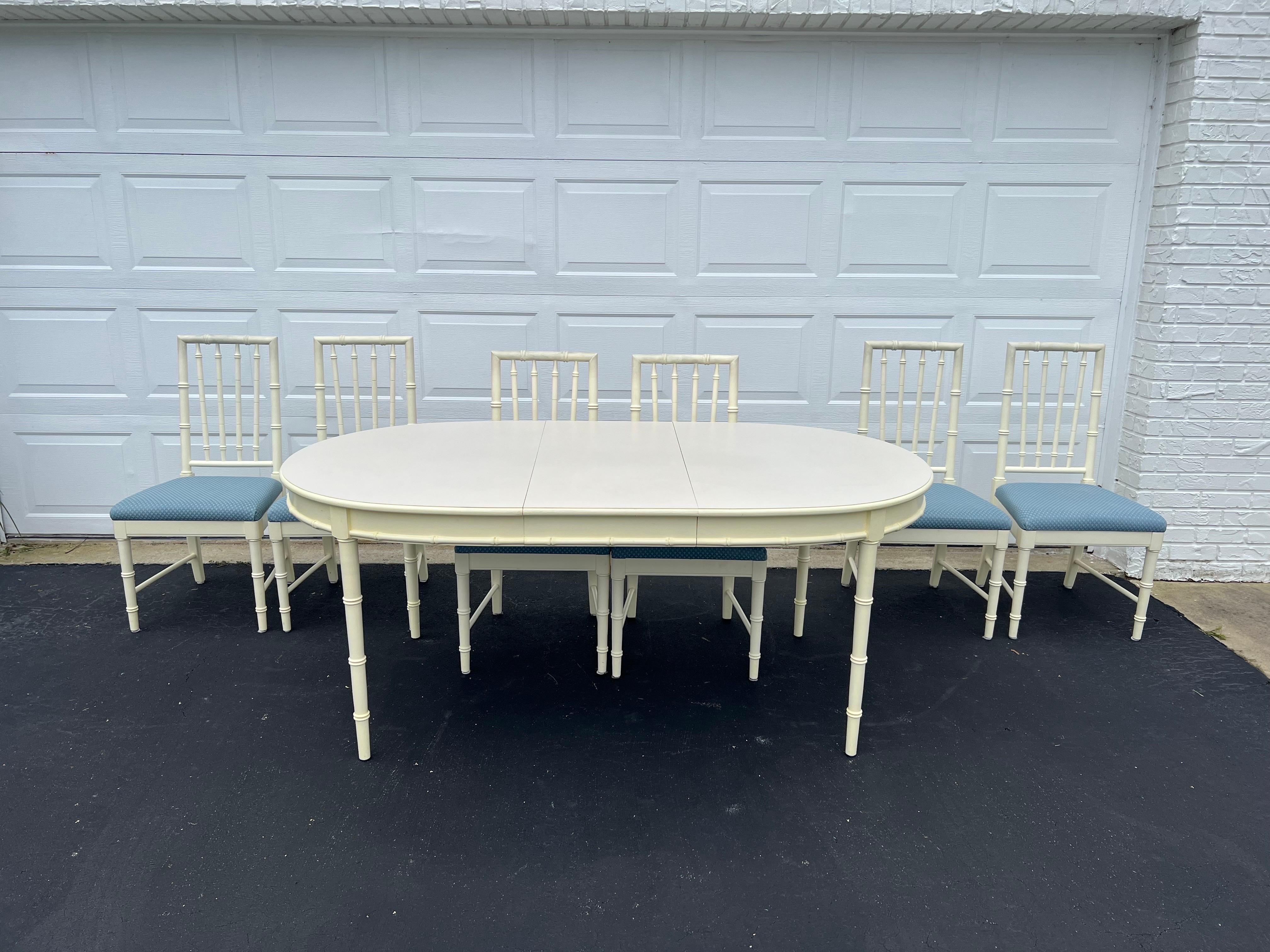 Faux Bamboo Dining Set by Thomasville. Nice solid wooden set that is very sturdy and timeless. Six solid wooden chairs with clean light blue upholstery. The table has a laminate top and has one leaf. This is a creamy white . Not a true white
Seat