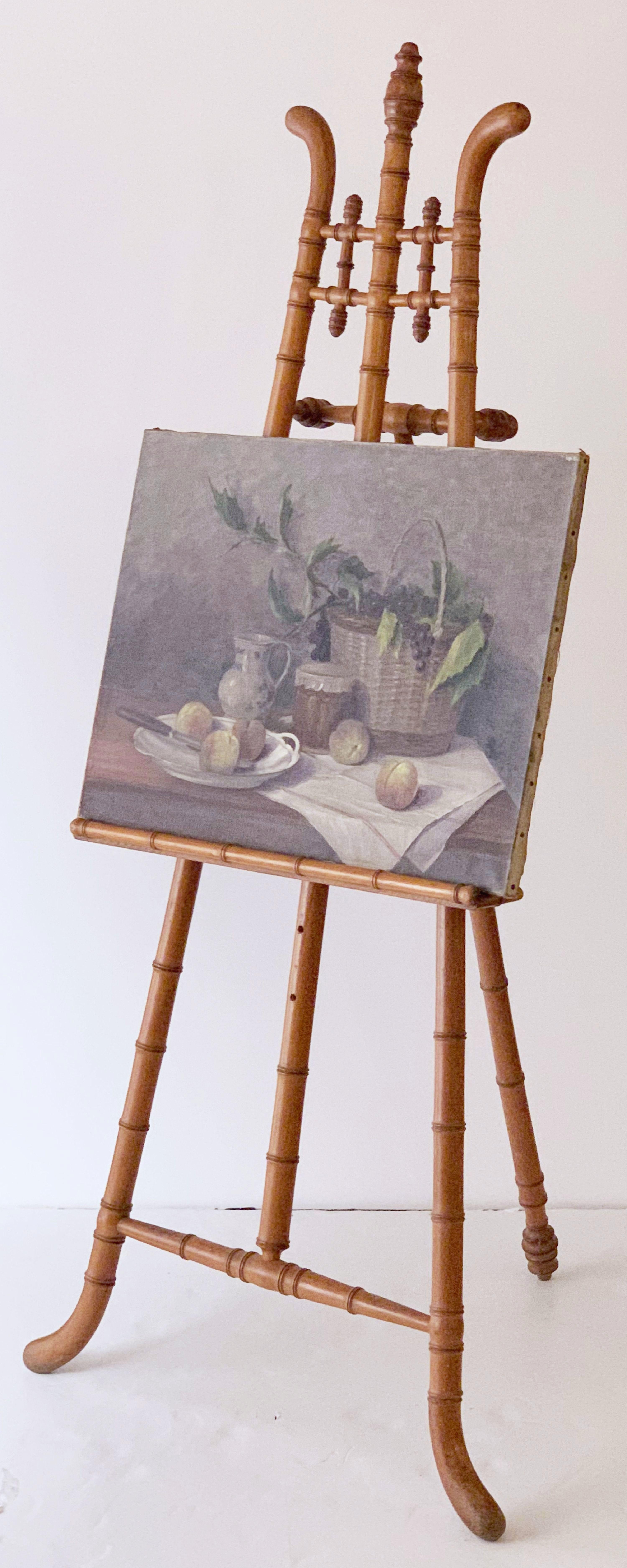 A handsome French faux bamboo display or artist's easel featuring a turned wood tripod frame with ornamental bamboo styling. 

The back leg with adjustable arm and locking wingnut. 

The cross bar support rest (for the artwork) adjustable