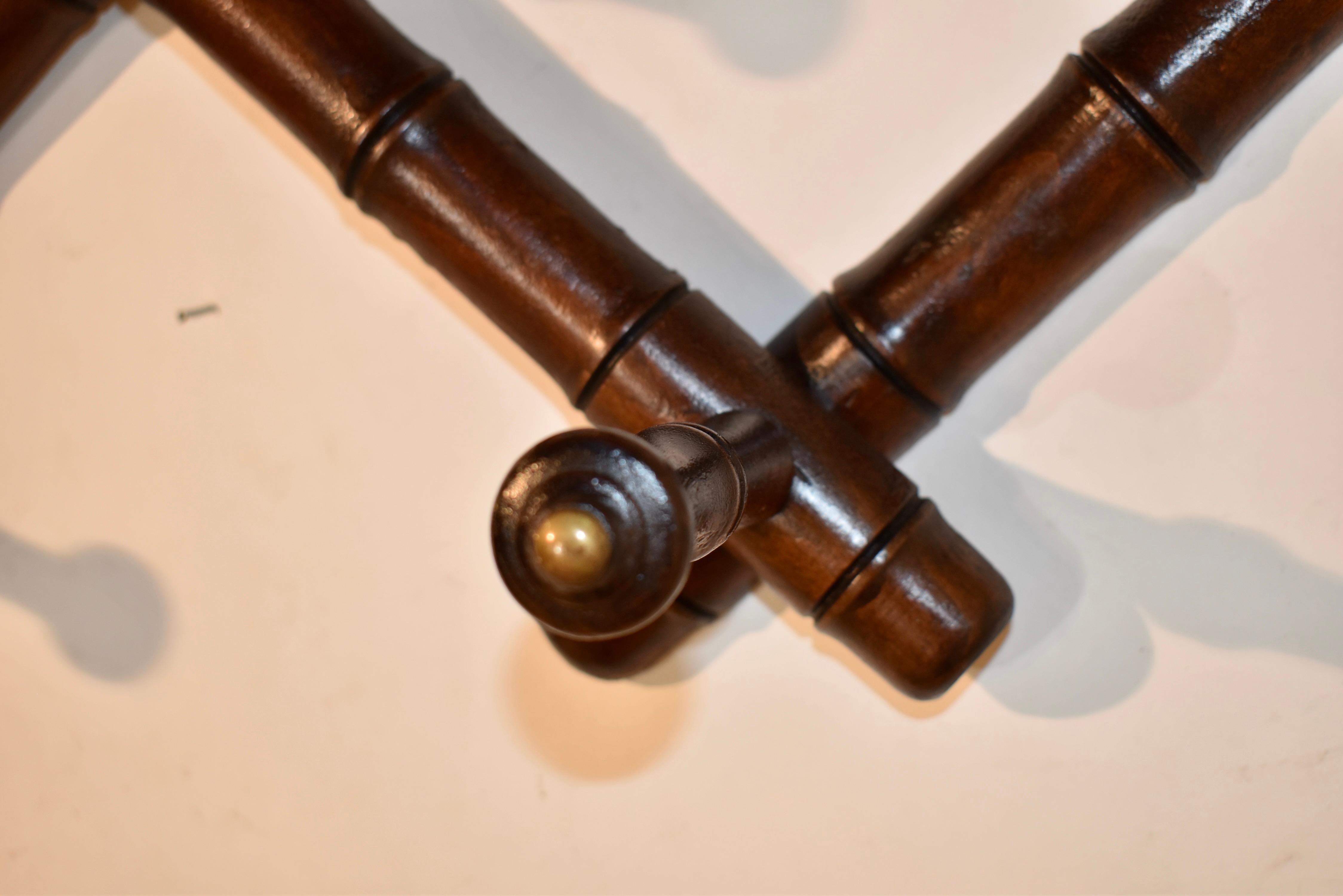 Circa 1900-1909 expandable hat or coat rack from France.  The rack is turned from cherry and has three hand turned hat hangers at the top, over seven hooks below for coats or other hangable items.  The rack as shown measures 38 w x 6.75 d x 17 h. 