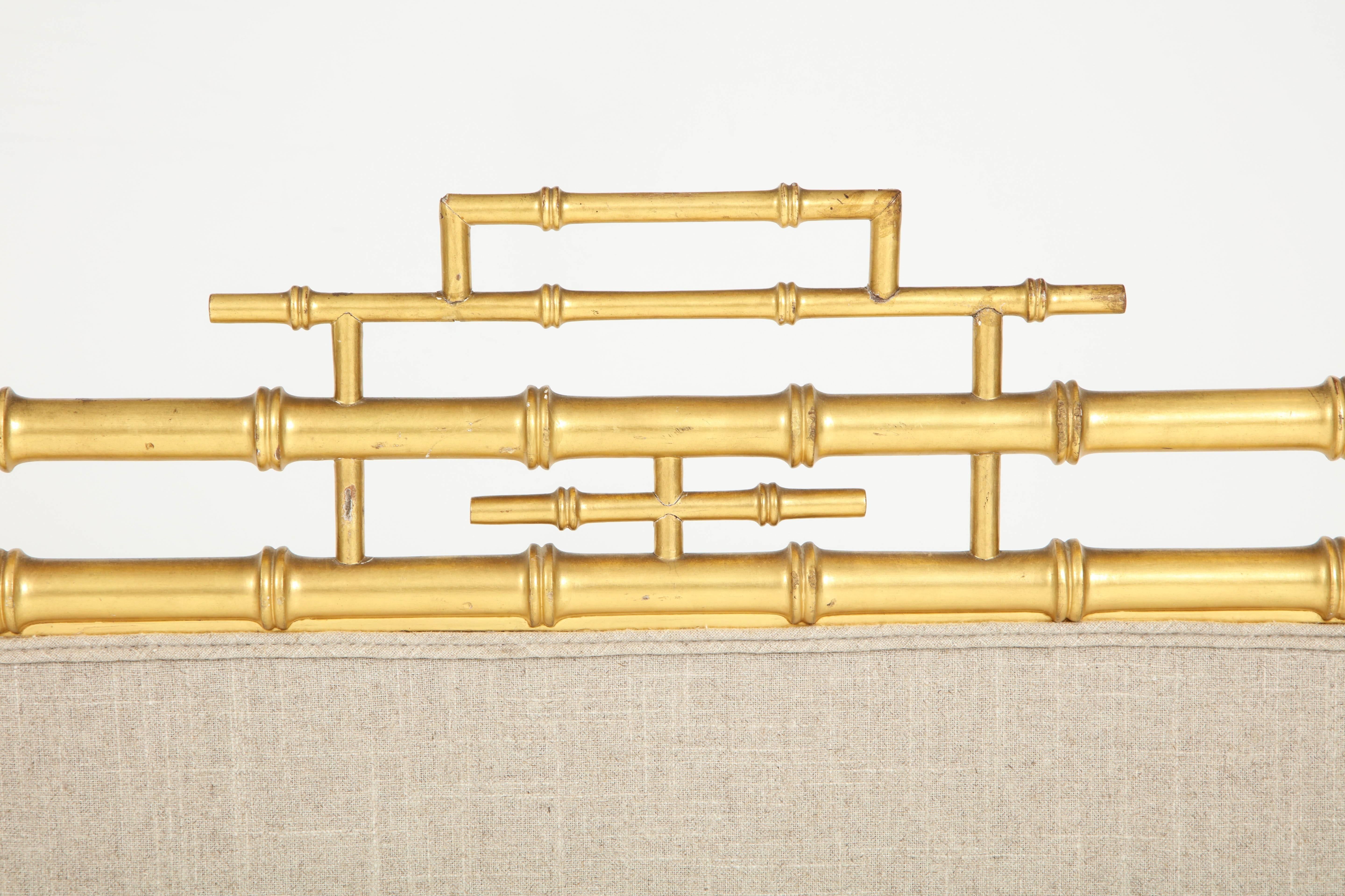 The picture of chic, this gold faux bamboo fireplace screen is the perfect way to cover the fireplace during summer months. Although the screen is currently upholstered in a natural linen, this can be changed to any fabric. The upholstered middle