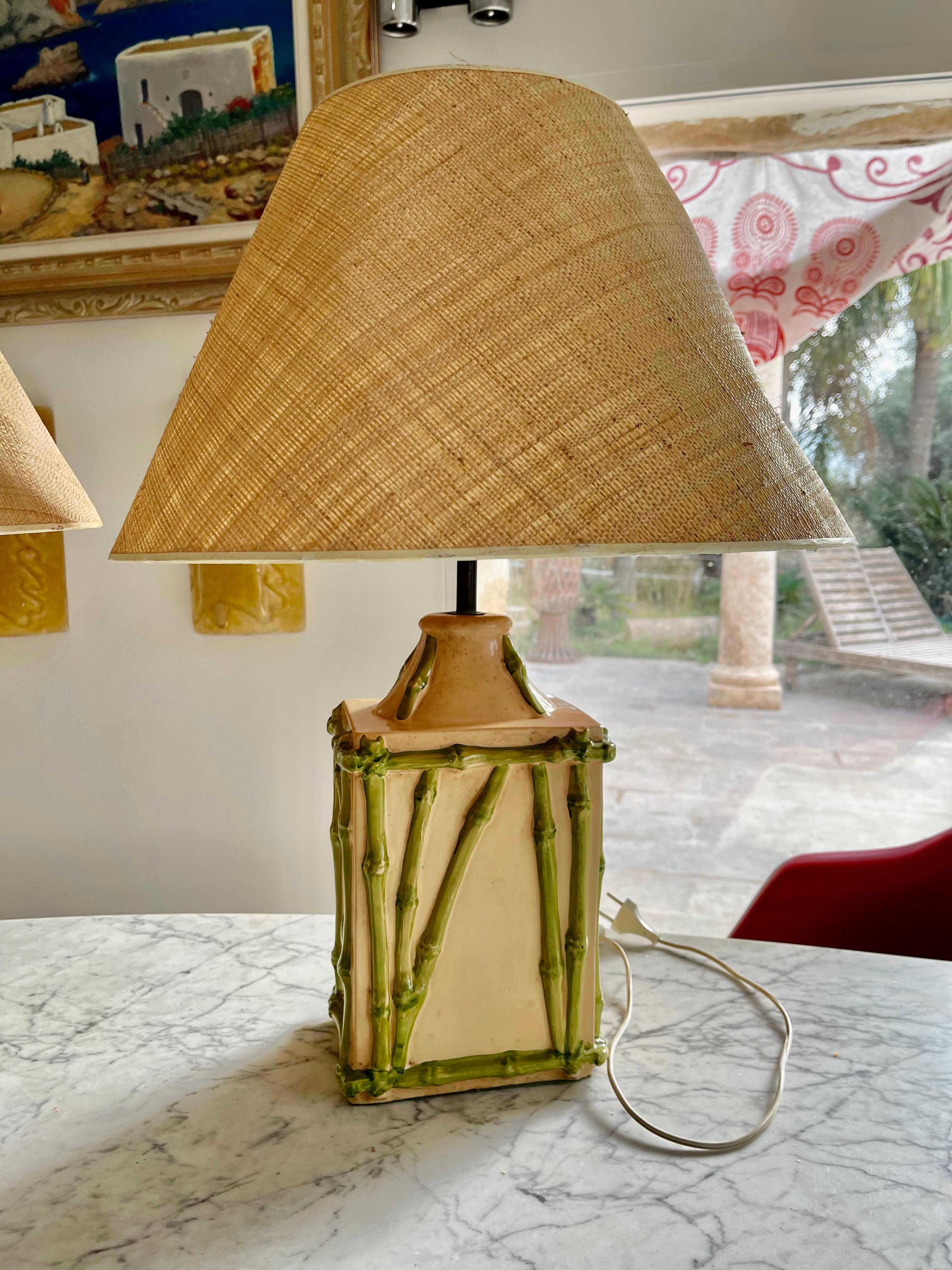 Hollywood Regency style, faux bamboo French ceramic table lamp Pair with green painted faux-bamboo trim circa 1970s. Please note of wear consistent with age including paint loss on the base.