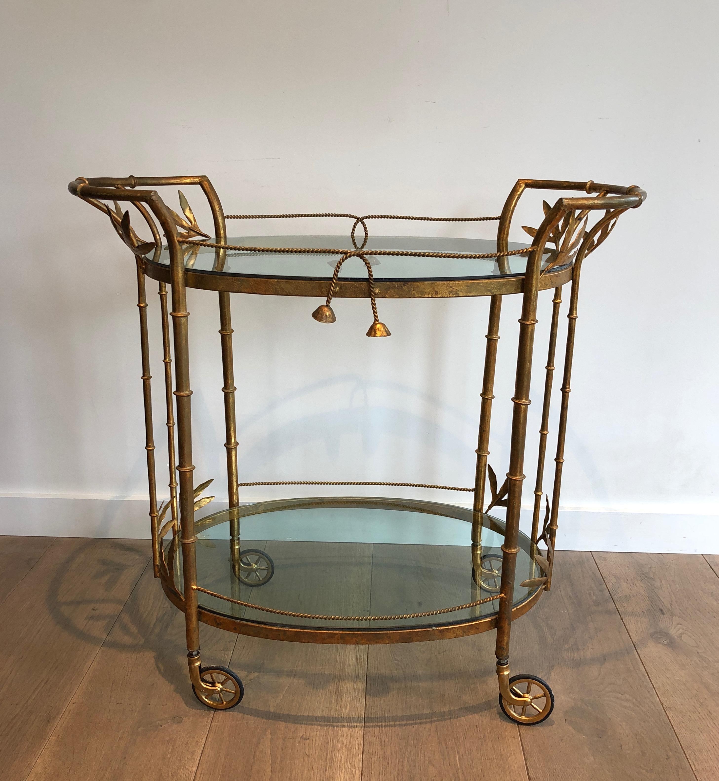 This faux-bamboo drinks trolley is made of gilt metal and blueish glass. This bar cart is a very rare model. This is a French work attributed to Coco Chanel. Circa 1970
