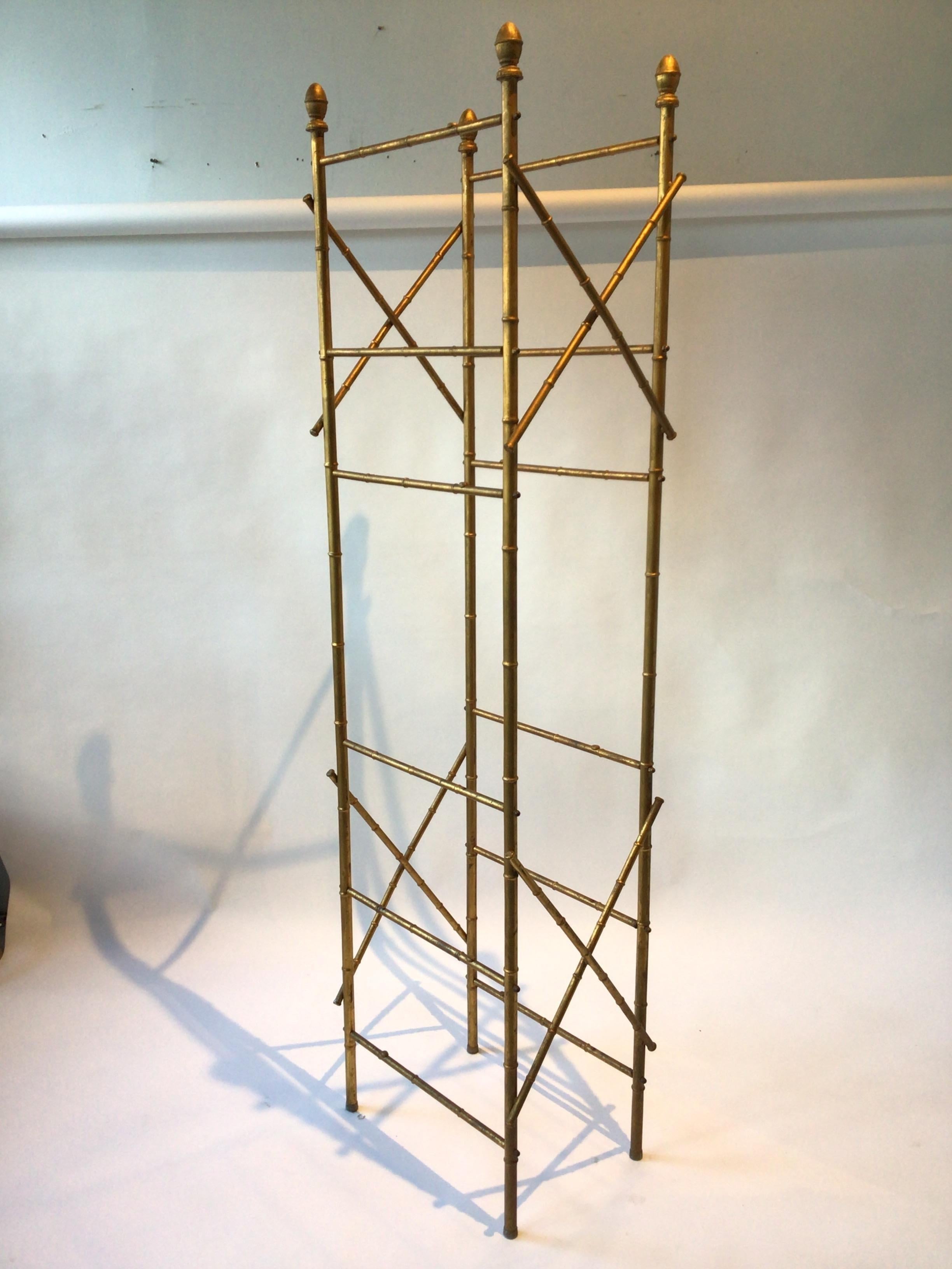 Faux bamboo gilt metal etagere. I’m having new glass shelves made for this piece.
