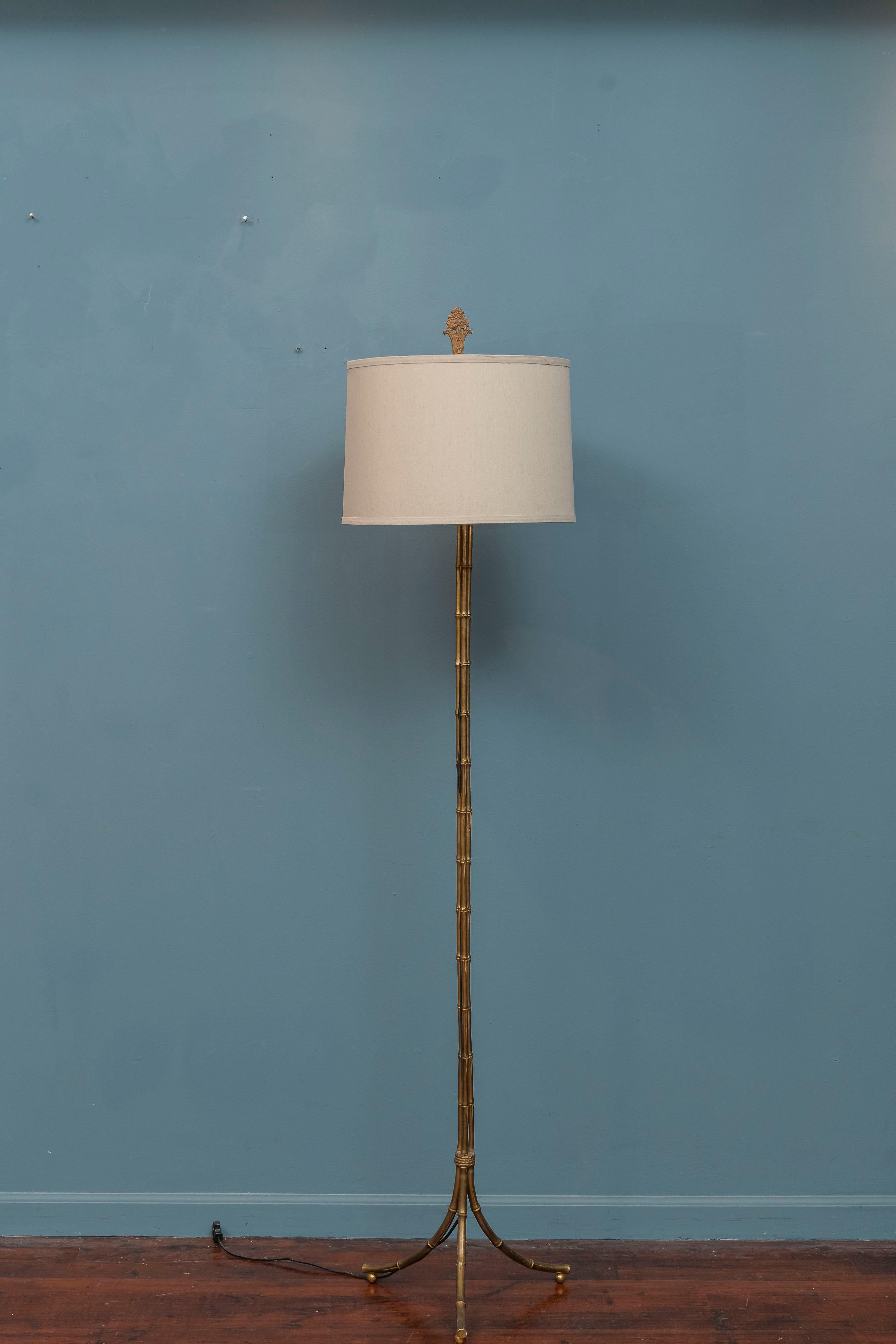 Faux bamboo gilt-metal floor lamp. Nice decorative lamp designed to look like bamboo with a painted finish on three ball feet and a 15