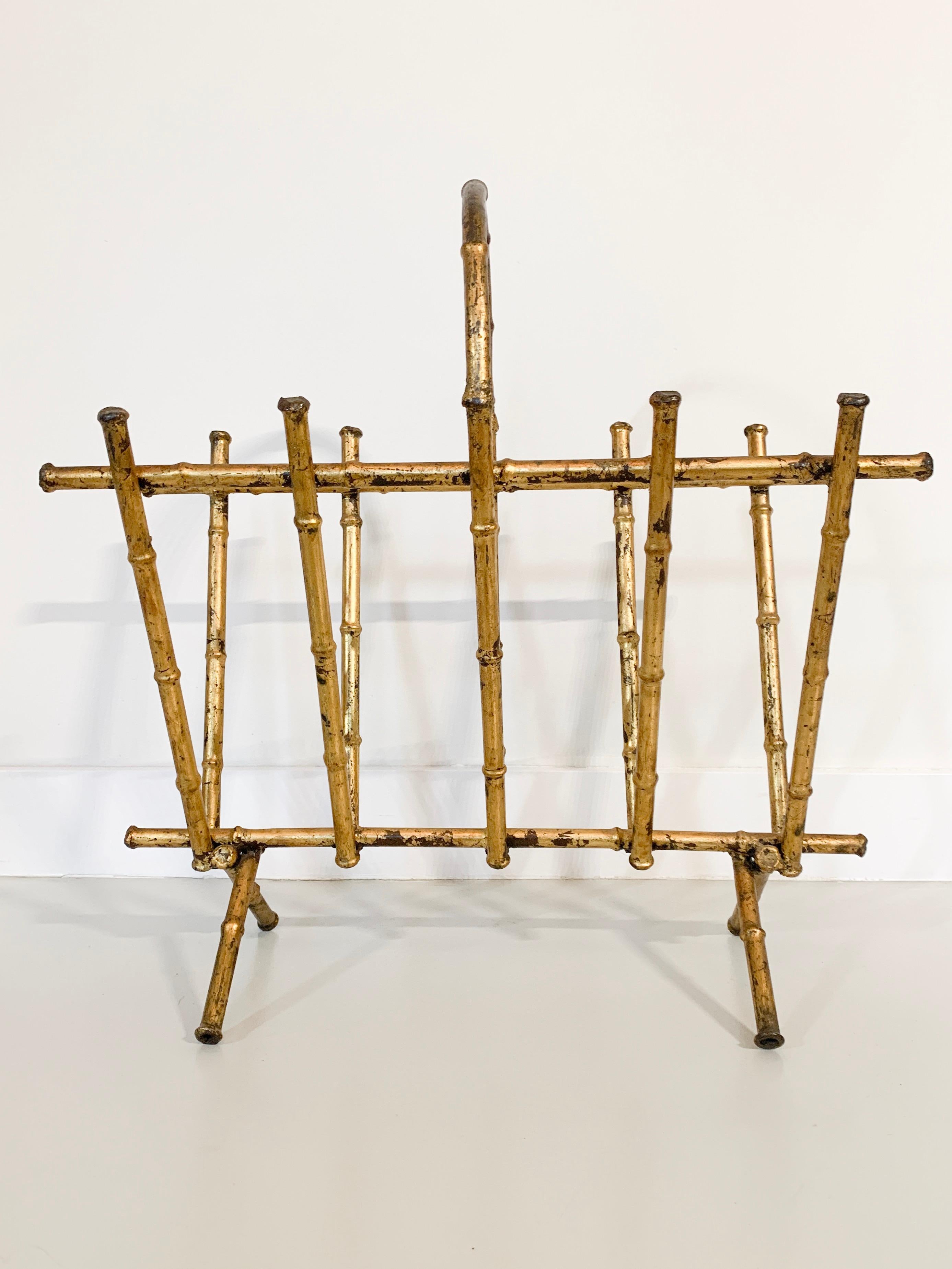 Gilded metal faux bamboo magazine rack circa 1950 which is both useful and adds a touch of Hollywood Regency glamour. Attributed to Maison Bagues.