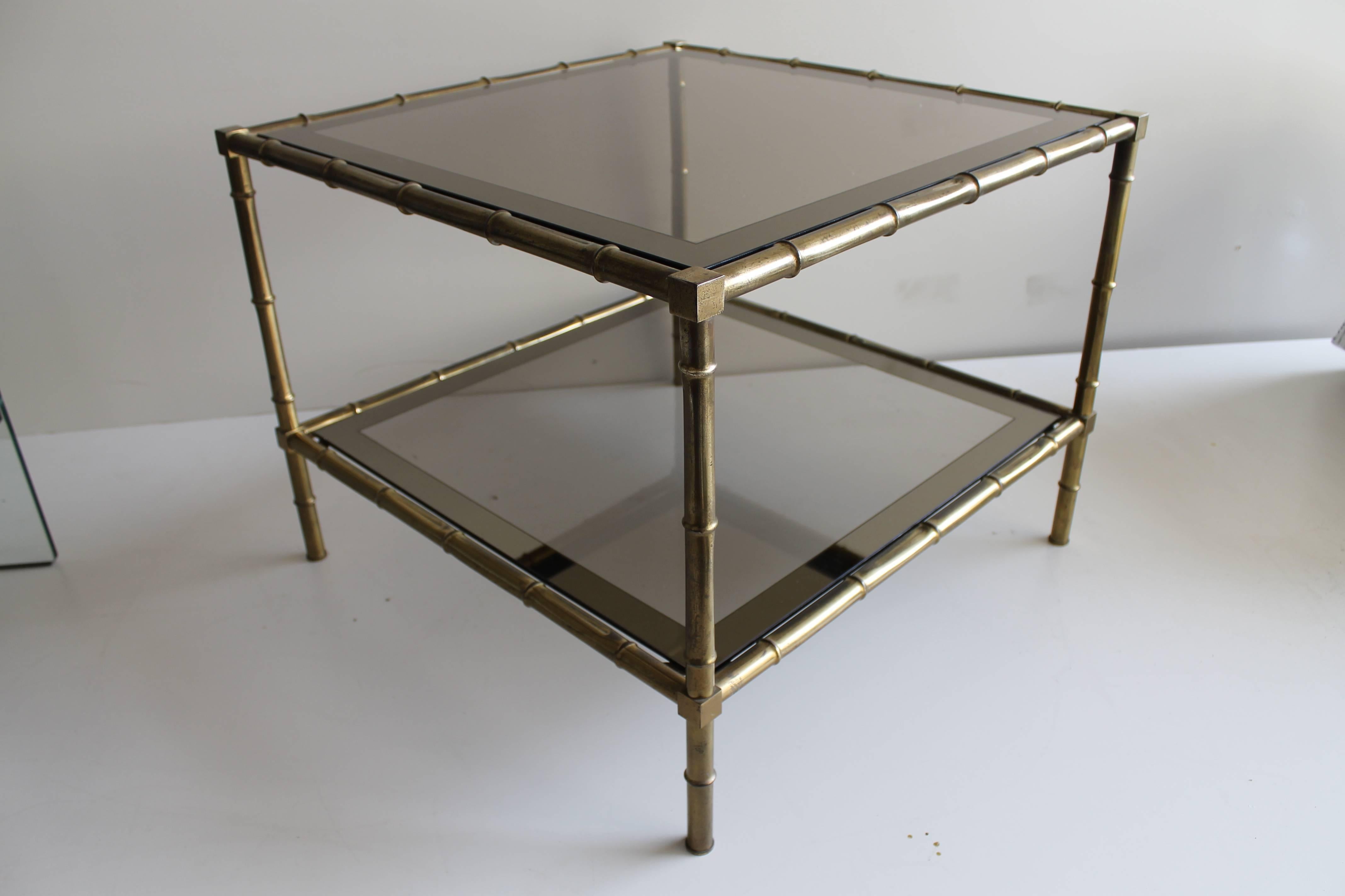 Italian modern squared coffee table with black smocked glass double top and faux bamboo gold brass legs. The top has a mirror frame on both levels. It is dated circa 1975.