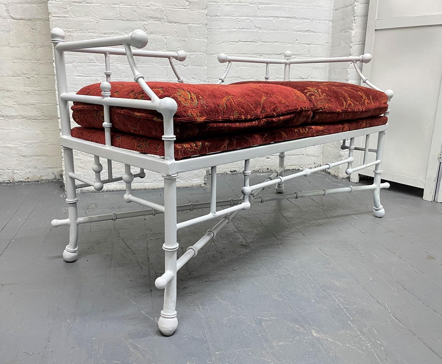 Hollywood Regency, faux bamboo cast iron bench. The bench has the original fabric with a white panted frame.