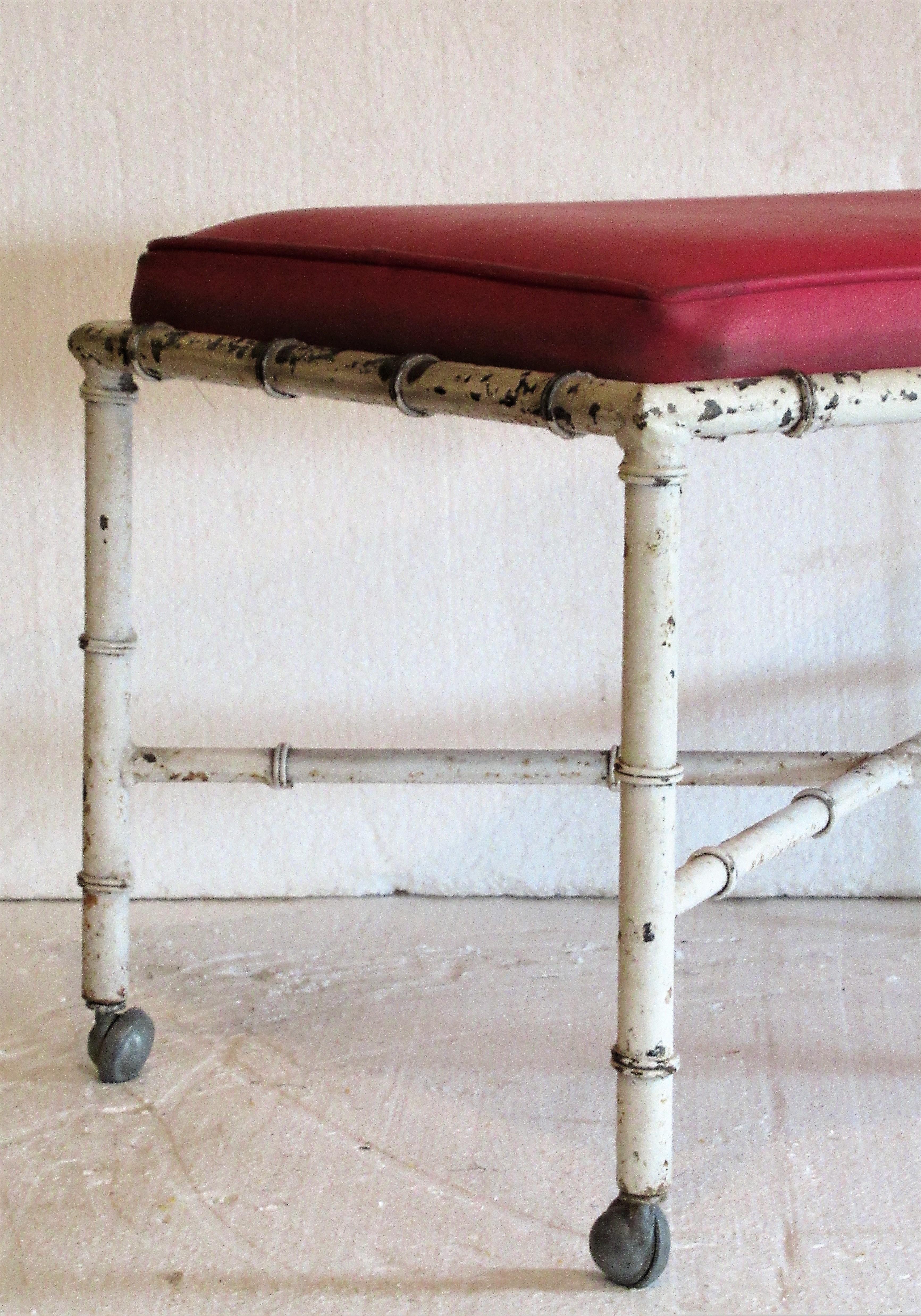 Old white painted faux bamboo iron stool or ottoman with nicely detailed metalwork and the four original small rolling aluminum casters. Good looking or great quality, circa 1960. Look at all pictures and read condition report in comment section.