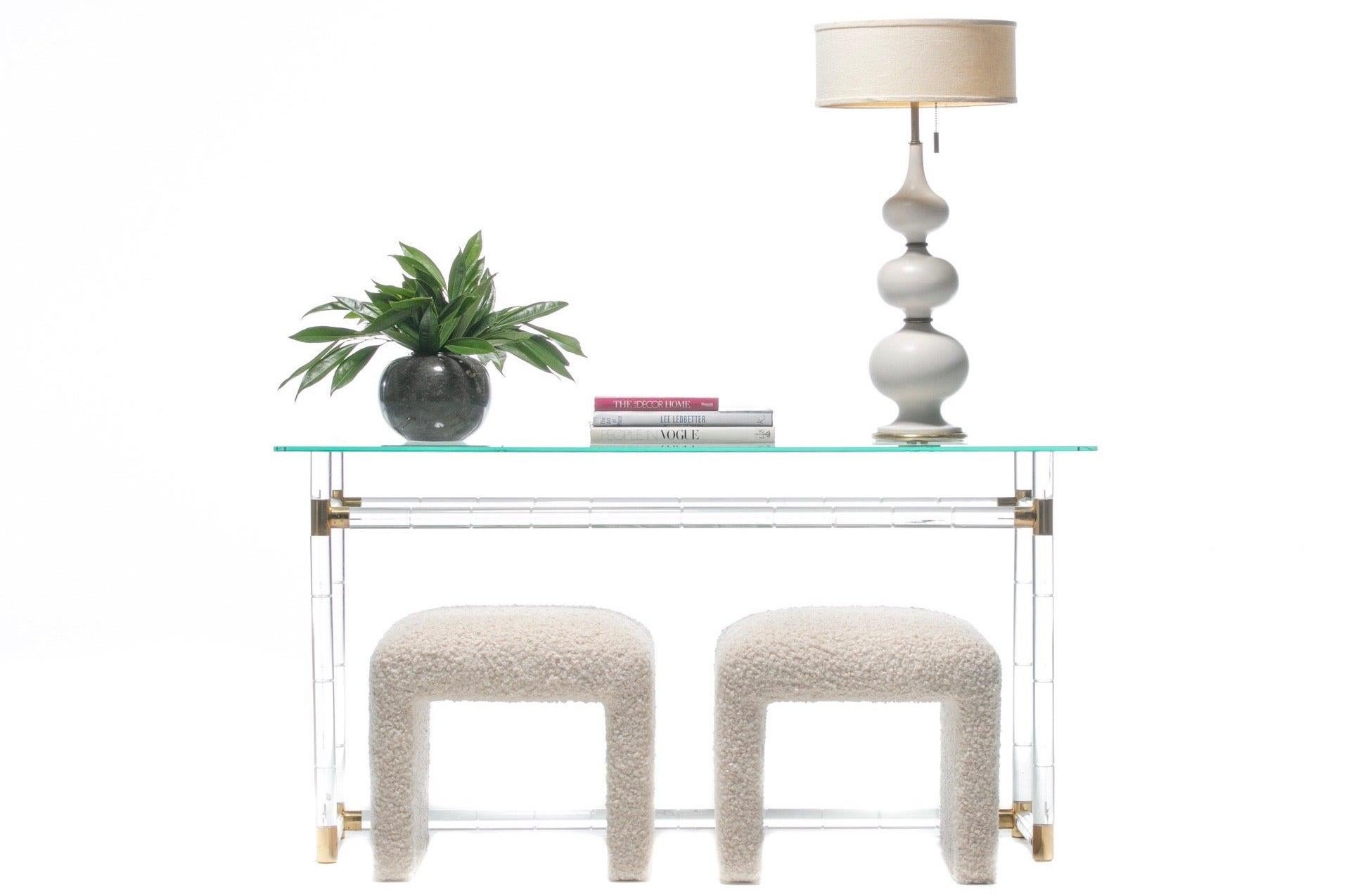 Charles Hollis Jones Faux Bamboo Console in lucite and brass. Faux bamboo form with brass connectors and glass top. Designed with inset on base ideal for tucking a pair of stools or bench underneath. Want to see more beautiful things? Scroll down