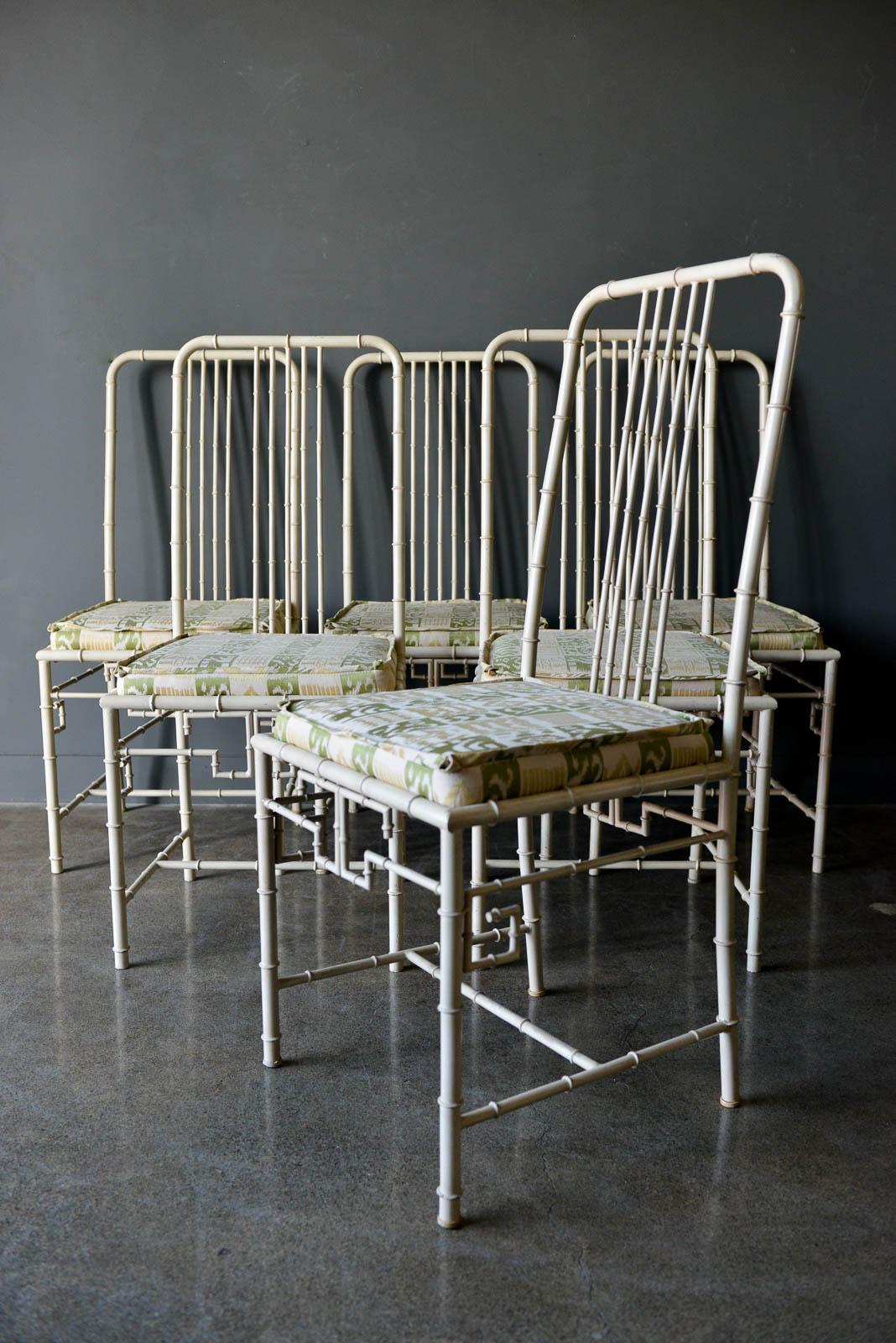 Faux bamboo metal dining chairs, ca. 1970. Beautiful greek key design with faux bamboo frames. Ivory frames are in good condition and seats are offered as shown, but can be recovered in C.O.M. on request. Frames are in good condition with age