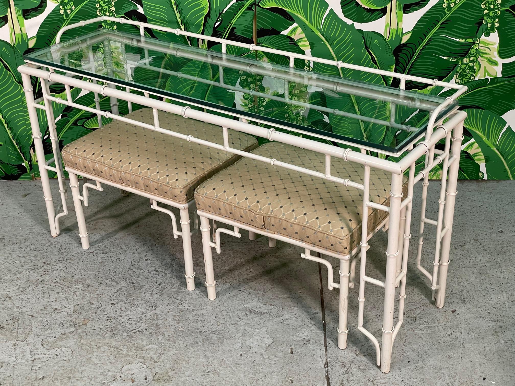 Vintage metal console table features faux bamboo detailing and matching footstools. Very similar to Warren Kessler. Very heavy and structurally solid. Good condition with minor imperfections consistent with age.
Table measures 54