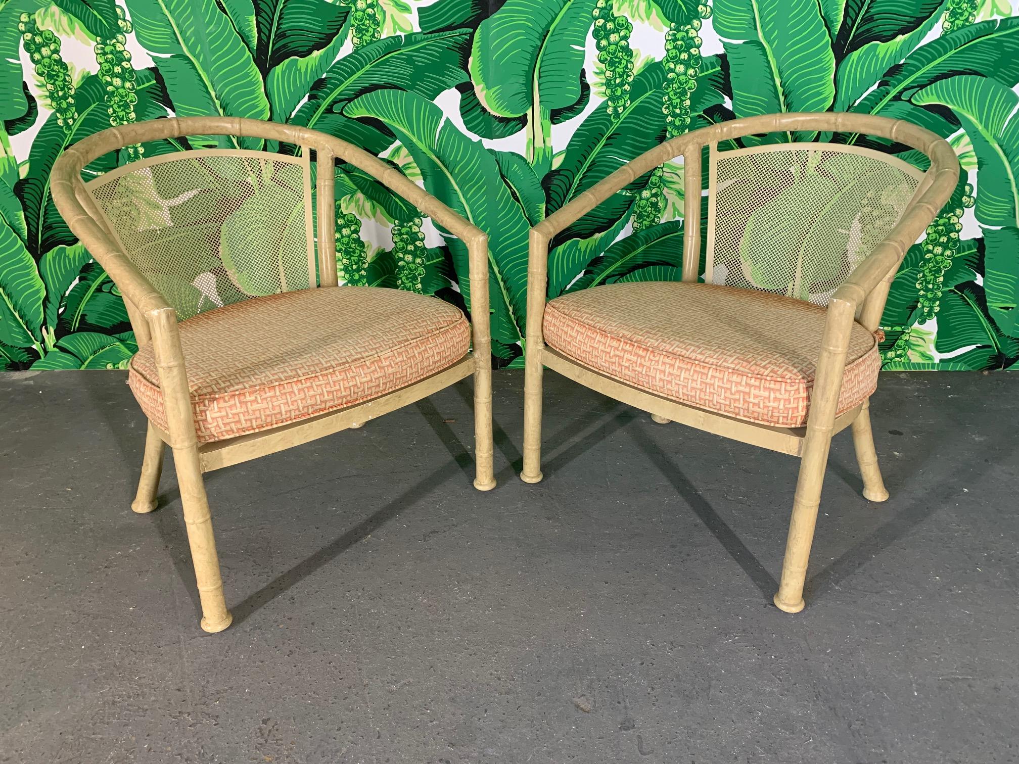 Pair of faux bamboo aluminum patio chairs by Meadowcraft. Good vintage condition with minor imperfections consistent with age, as well as fading to cushions.