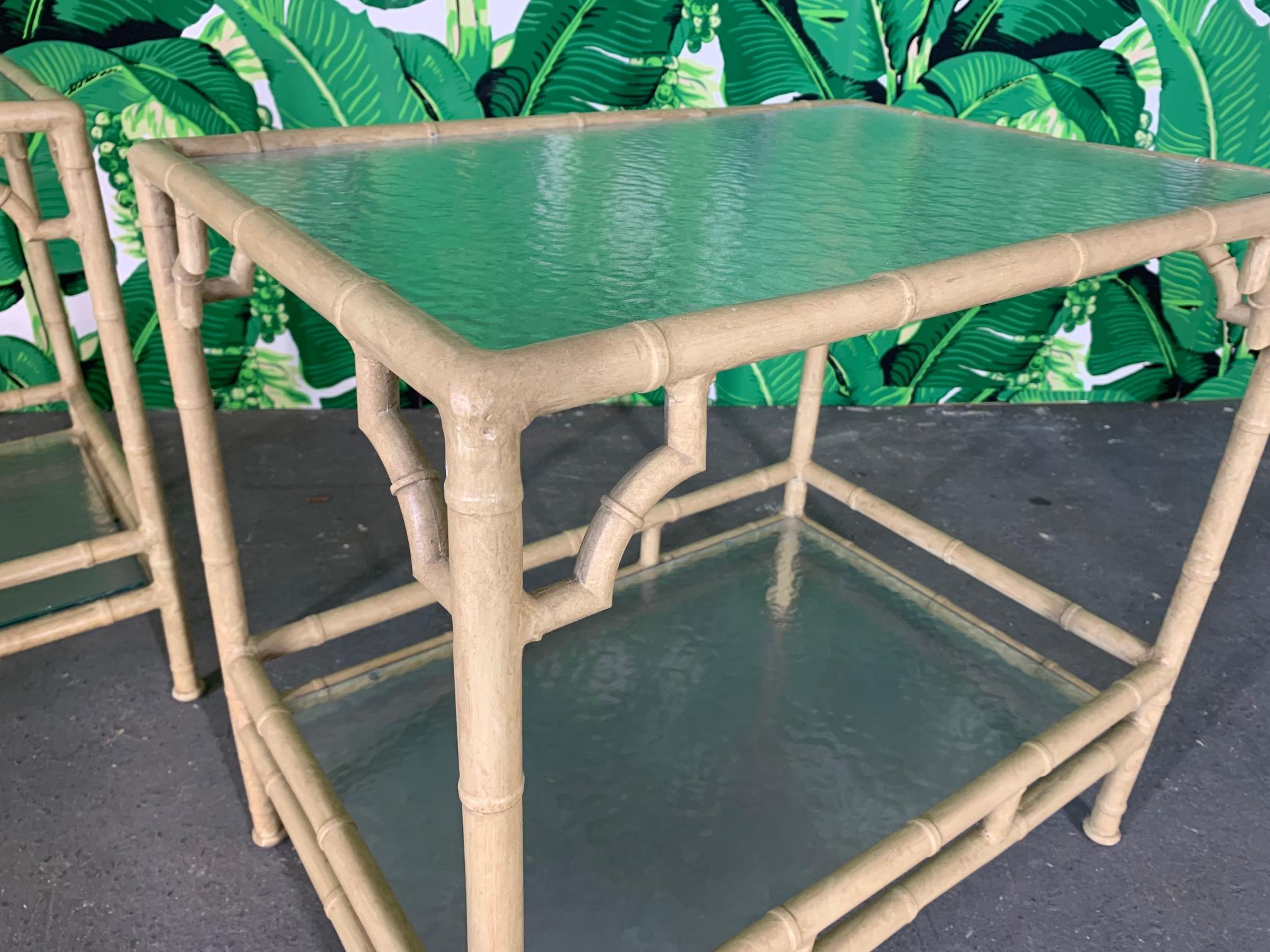 Set of two metal patio end/side tables by Meadowcraft feature faux bamboo styling and double glass shelves. Very good condition with minor imperfections consistent with age.