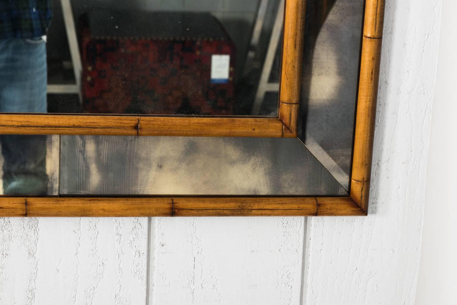 Large faux bamboo mirror with smokey inserts around the border, circa 20th century.
 