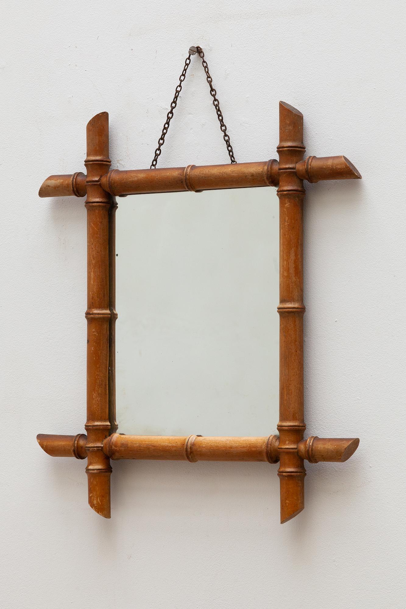 Antique bamboo wall mirror made cut from fruitwood manufactured in Cirey sur Vezouse, France. Labeled. Hangs from a small chain. The original label still attached. Dimensions: 42 W x 47 H x 4 D cm.