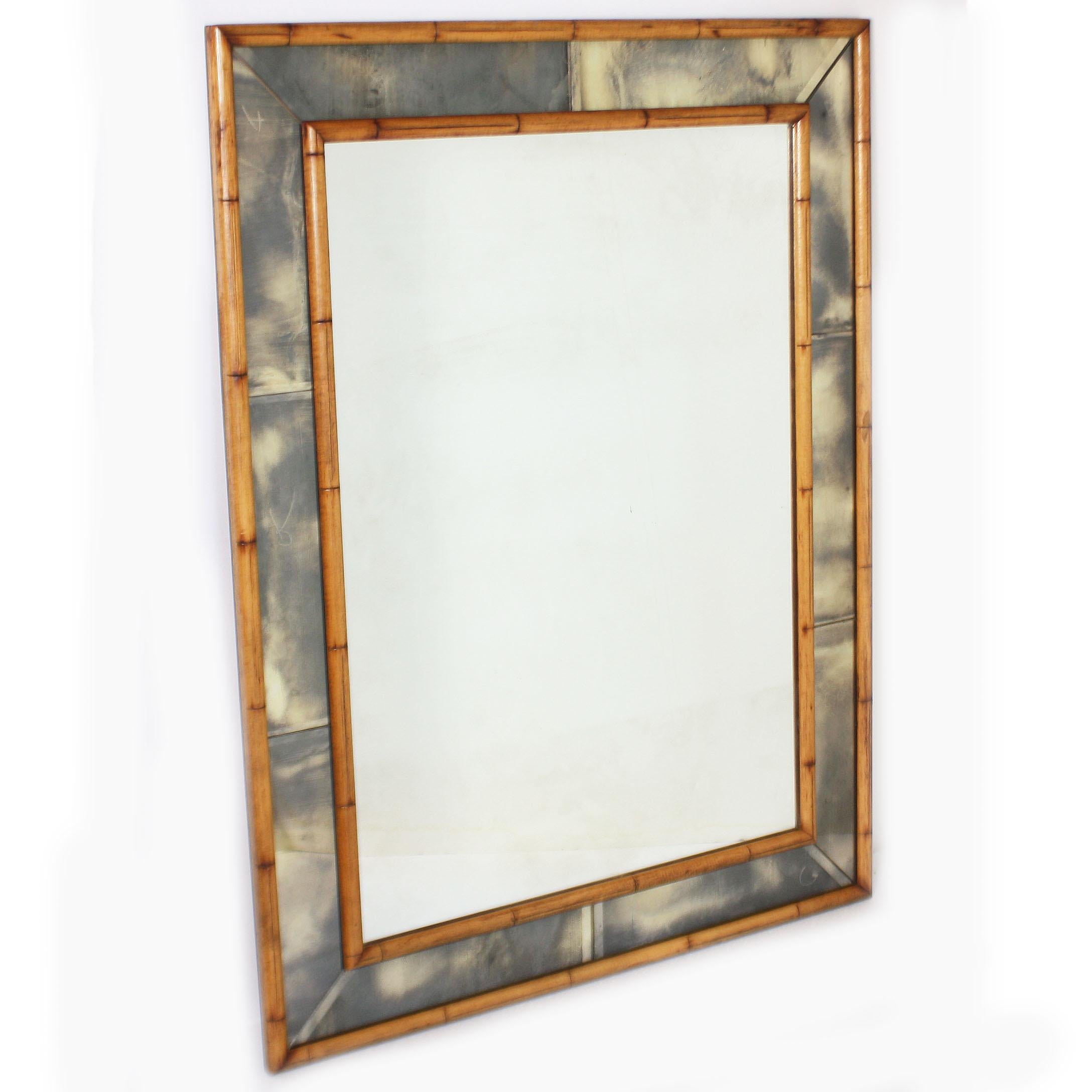 Faux bamboo mirror with smokey mirrored frame, circa 1970.
$3900.