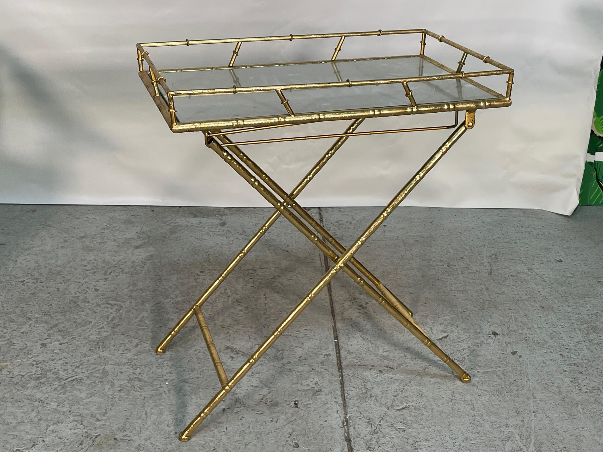 Gold metal serving tray features faux bamboo detailing and a mirrored top. Folds easily for storage. Very good condition with only very minor imperfections consistent with age.
Measures 24