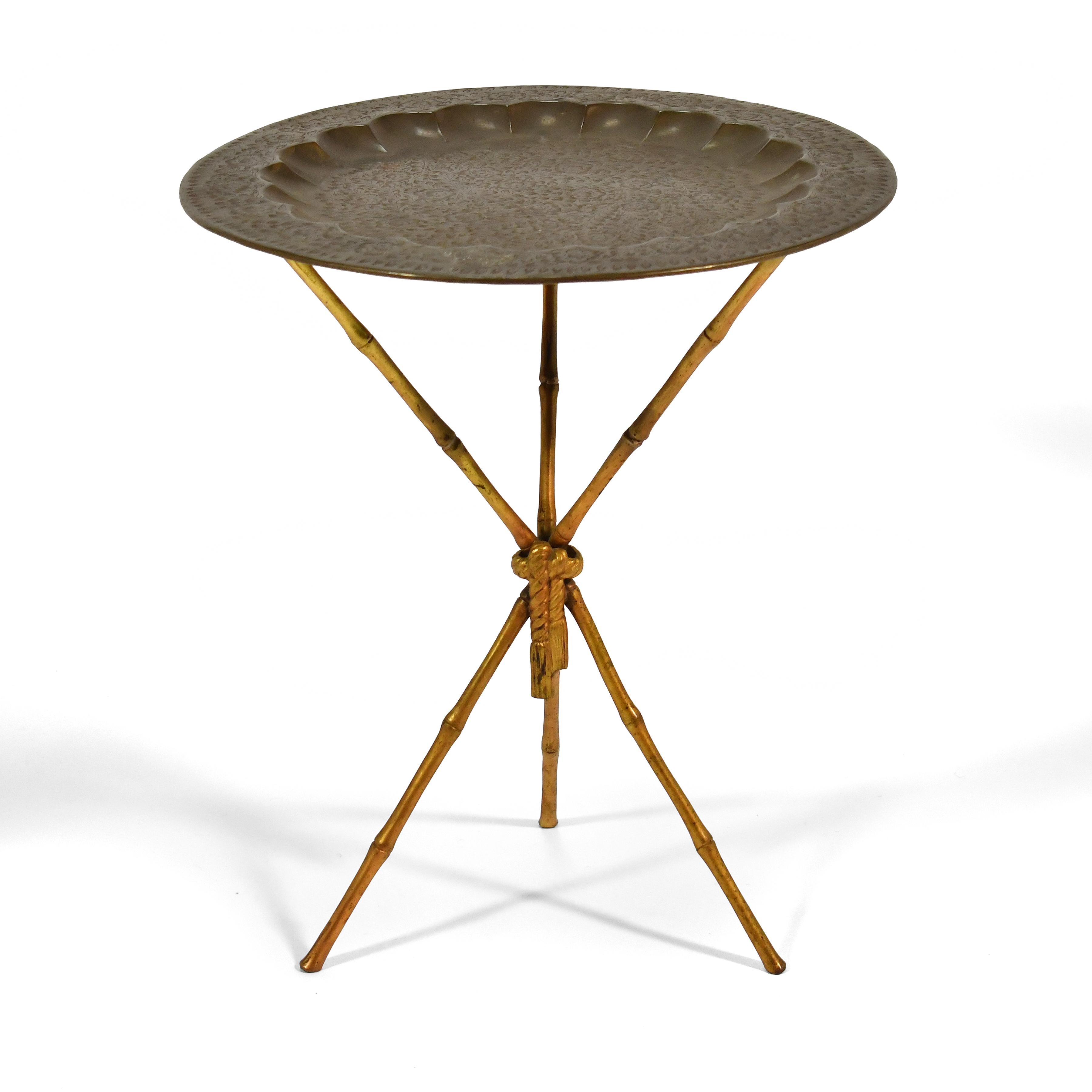 This slender, light, side or end table has a faux bamboo tripod base in the manner of Arthur Court made of either brass, or aluminum with a gold finish. It can support a glass top, but we acquired it from the original owner with this vintage etched