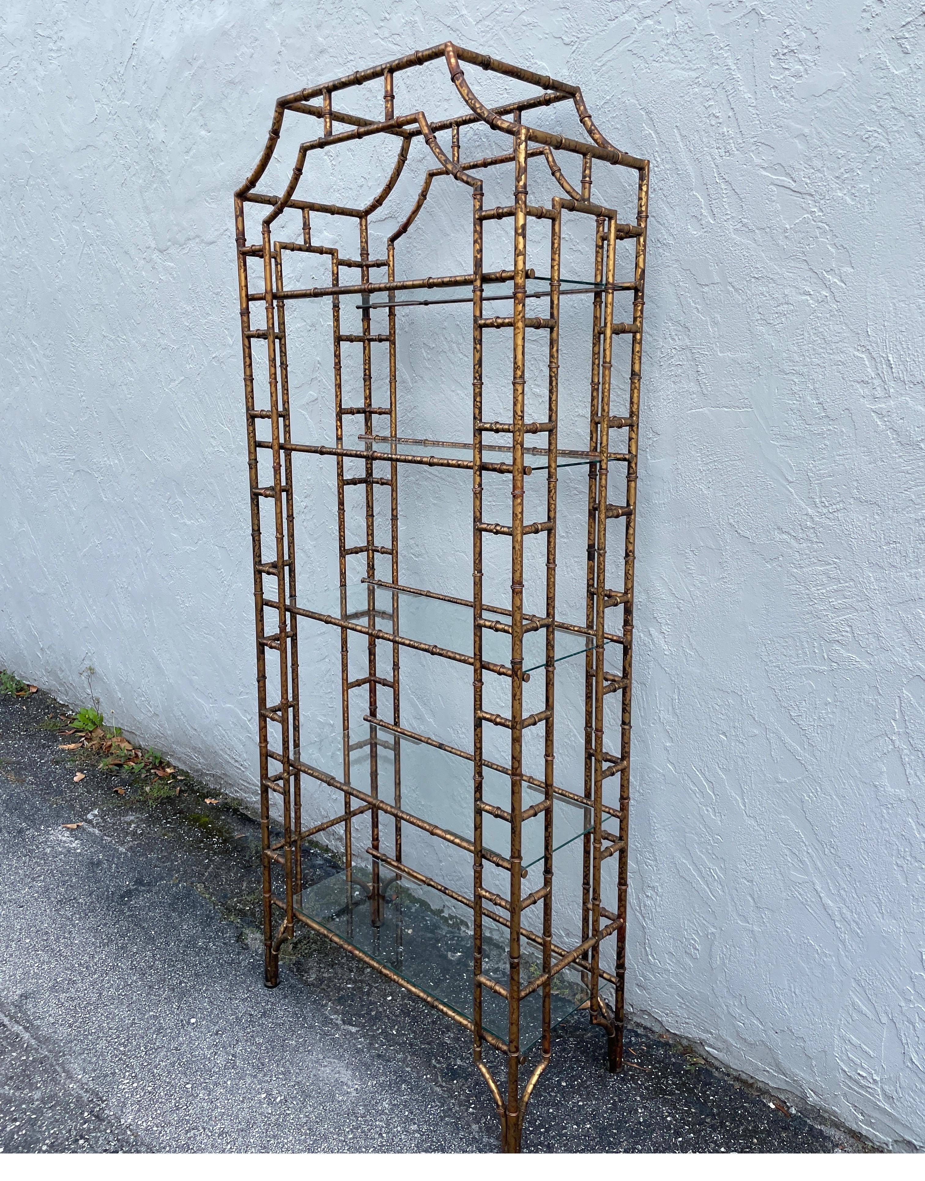 Pagoda style faux bamboo tole etagere with a painted tortoise finish & five glass shelves.