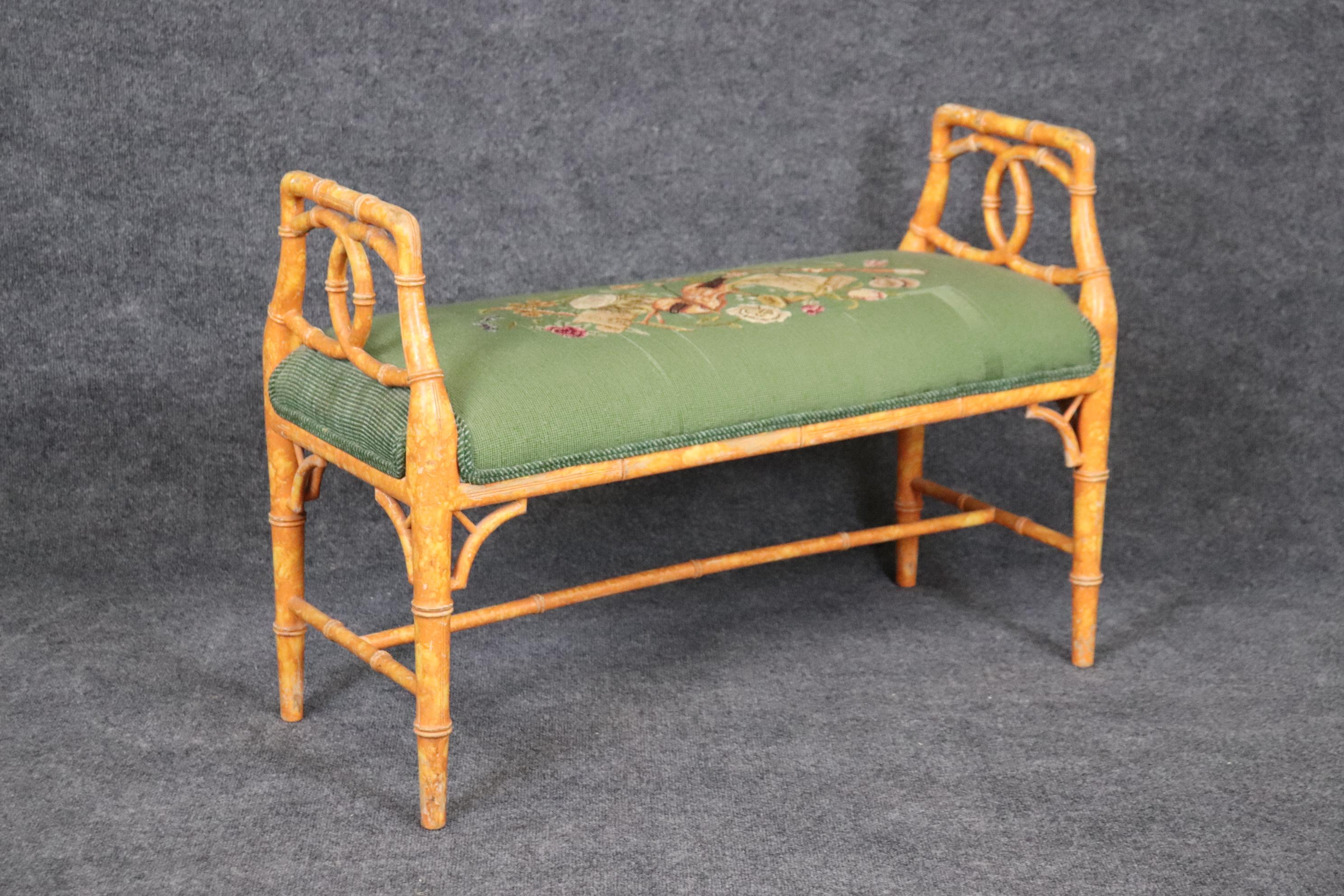 This is a gorgeous faux bamboo bench with needlepoint upholstery depicting volins and musical themes. The bench shows a distressed finish and is original. Measures 25.25 tall x 36.25 wide x 15 deep and seat height is 18.5. dates to the 1950s era
