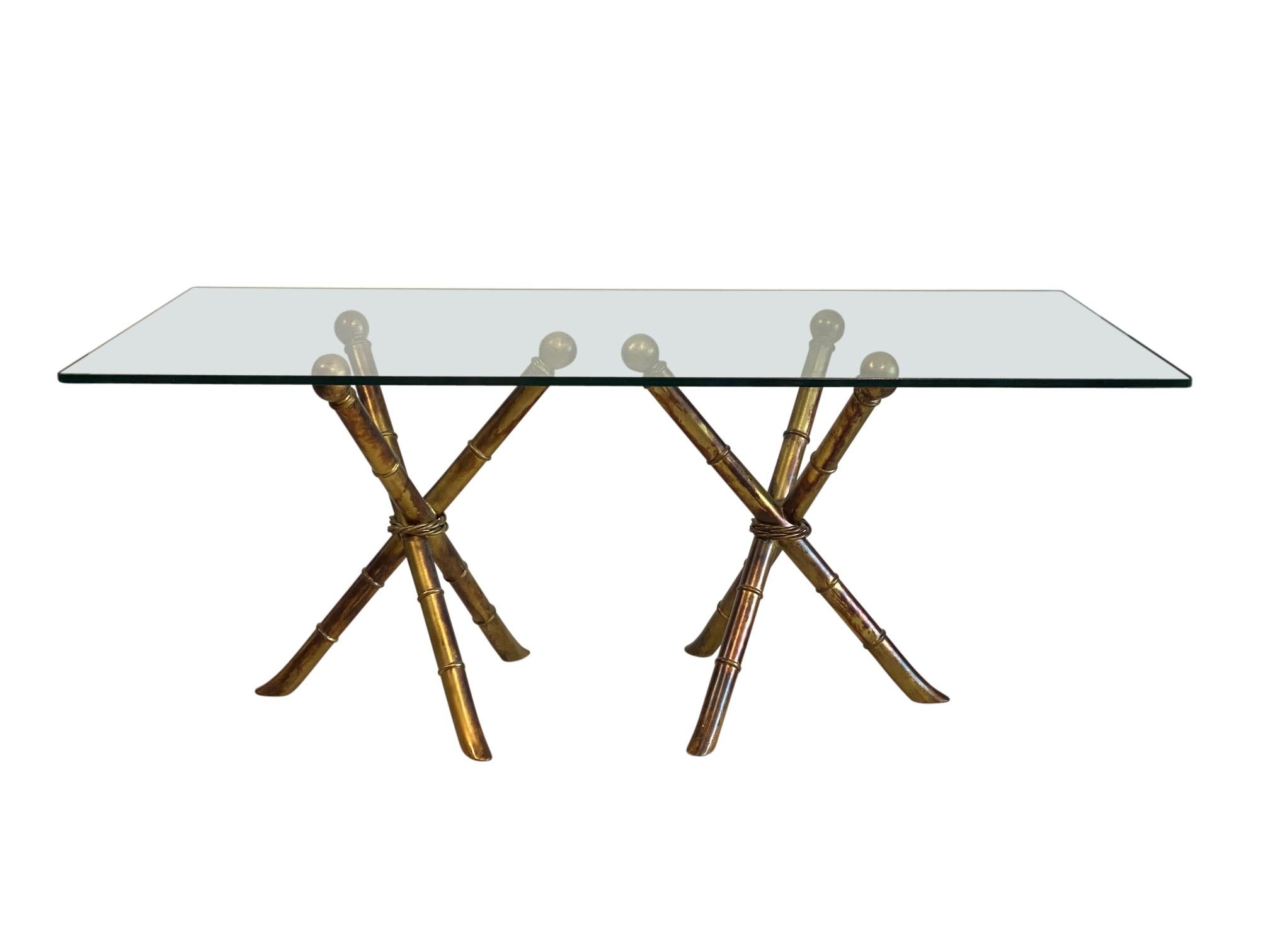Faux bamboo painted metal dining table with glass top.