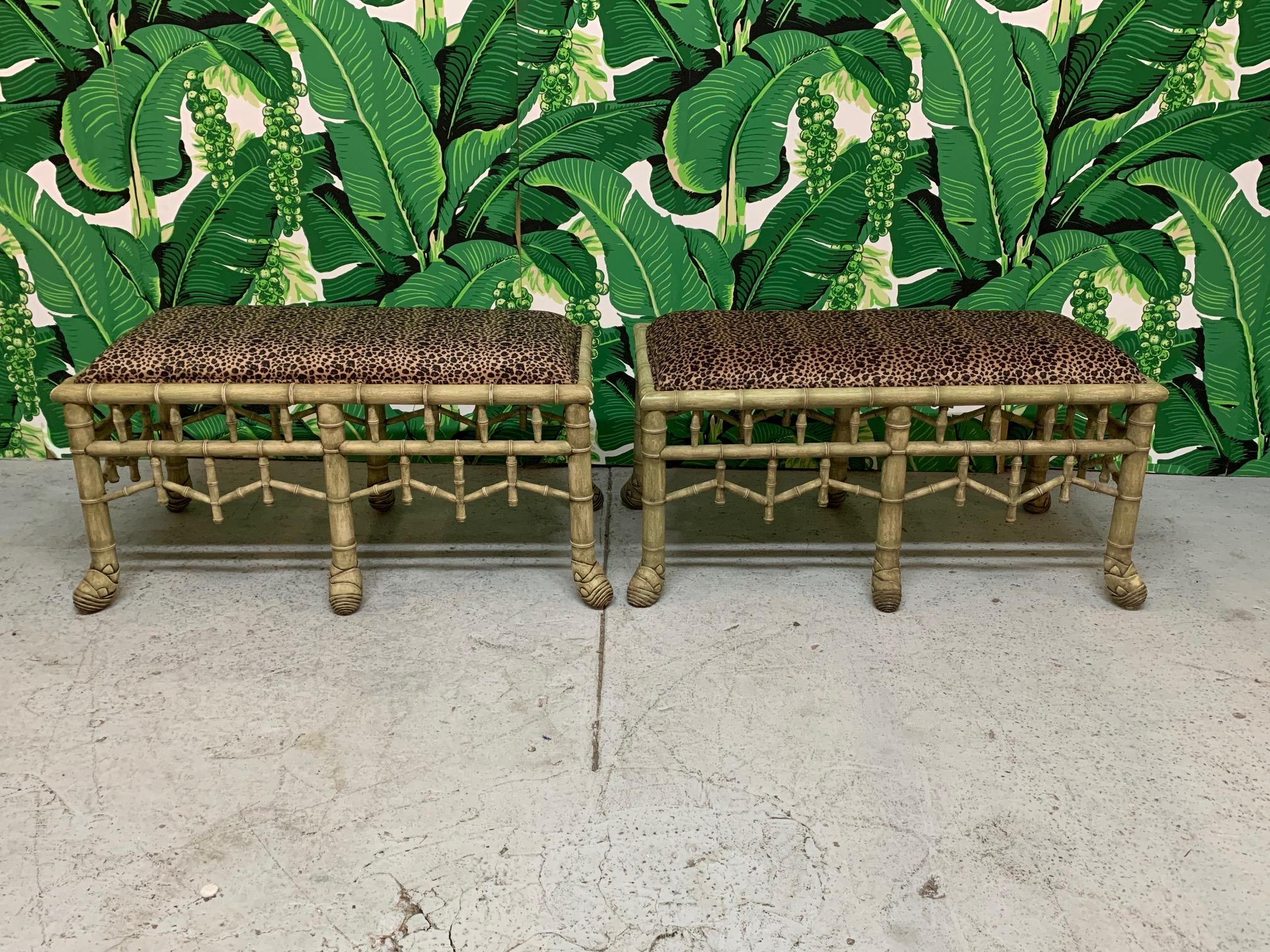 Pair of faux bamboo benches upholstered in leopard print fabric in the style of Brighton Pavilion seating. Good condition with only minor imperfections consistent with age. May exhibit scuffs, marks, or wear, see photos for details. 
For a shipping