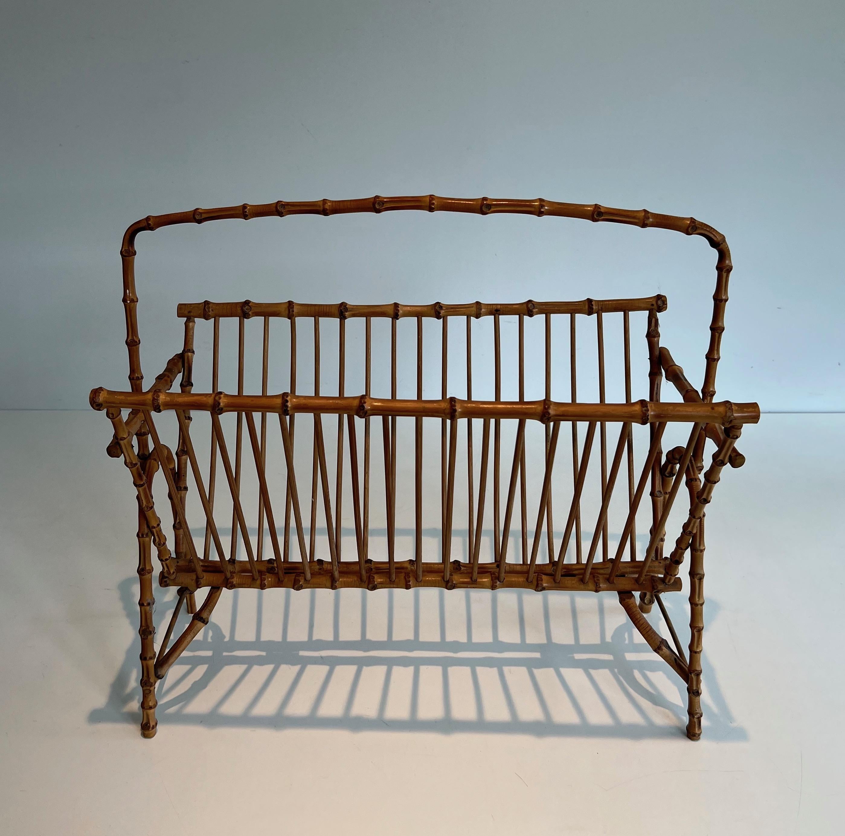 This faux-bamboo magazine rack is made of rattan. This is a very fine and decorative French work. Circa 1950