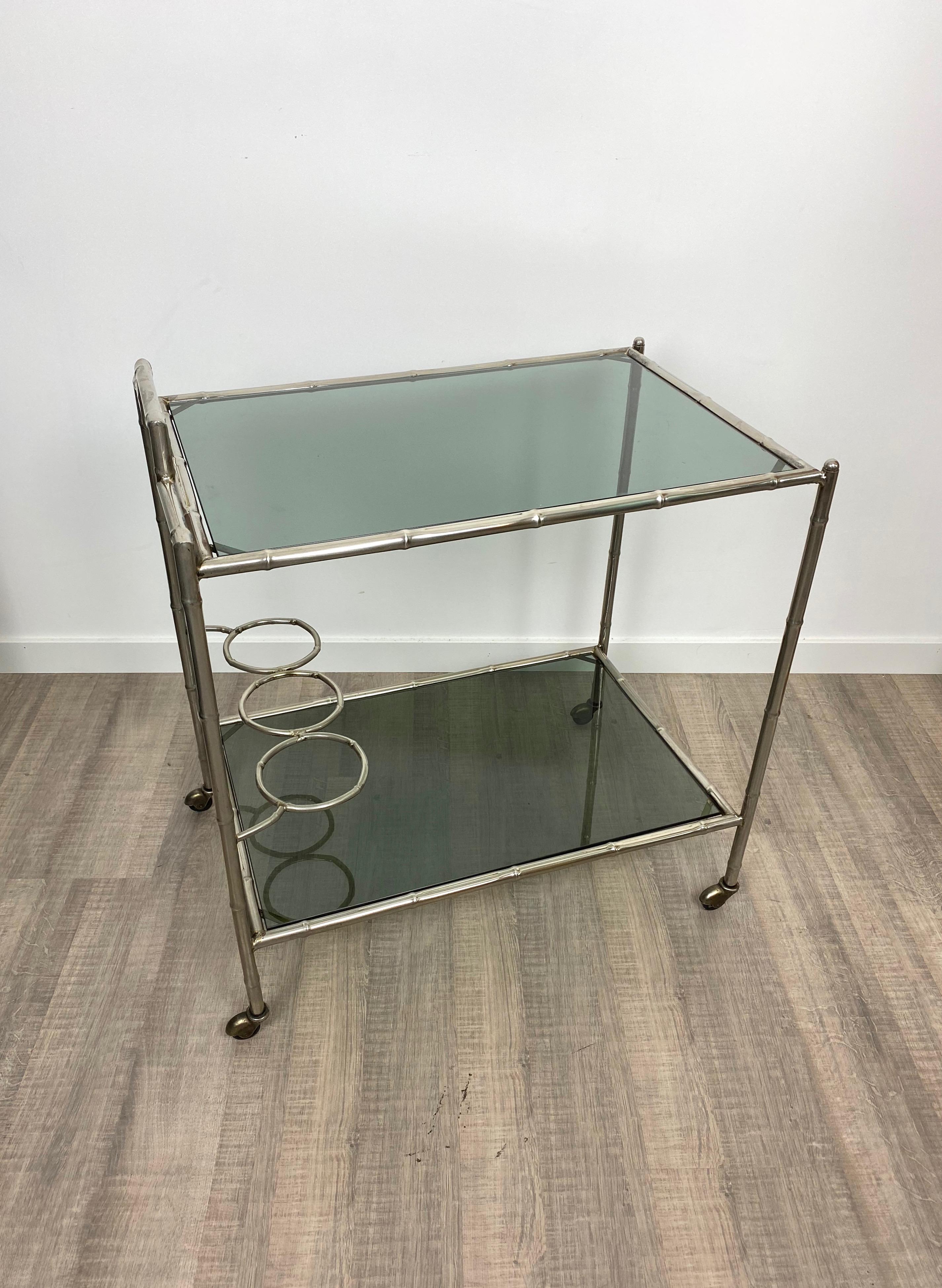 Serving cart trolley in a silver faux bamboo structure and two smoked glass shelves. A rare typical Italian 1970s piece of design.