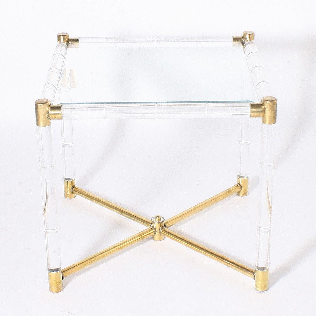 Faux bamboo table with lucite and brass detailing, circa 1970.
Measures: 24” square x 22” height.