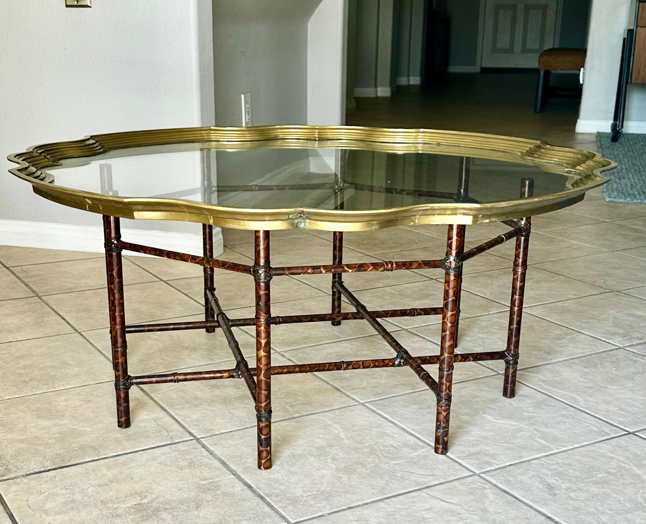 Round scallop edge brass and glass inset top coffee table. Supporting the top is a faux bamboo 