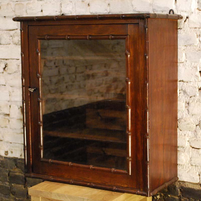 A small French hanging display cabinet or apothecary made in solid pitch pine.
The faux bamboo details are made in solid cherrywood as it resembles both color and structure of real bamboo.
The cabinet has adjustable shelves and there are forged