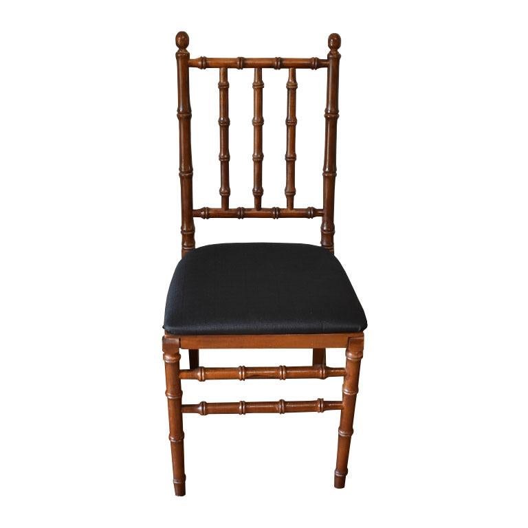 A pair of two faux bamboo dining chairs, with black upholstered seats. Each chair folds for easy storage. 

Dimensions:
16.5