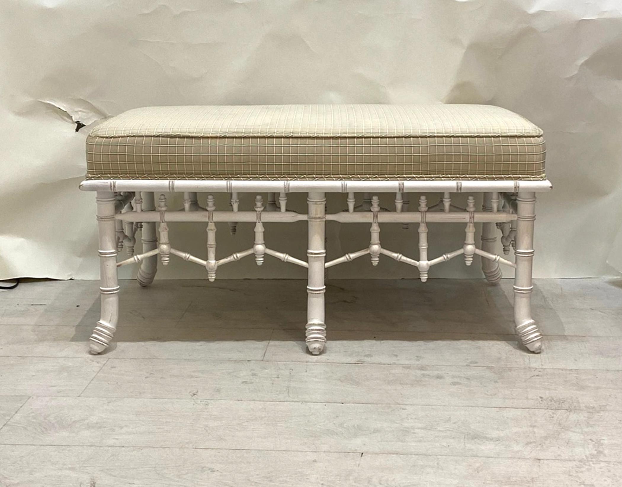 Faux bamboo bench turned wood bottom. Well made quality construction built to last. Has the original upholstery on the top fabric is in good condition though shows some signs of use. Some wear to painted finish.