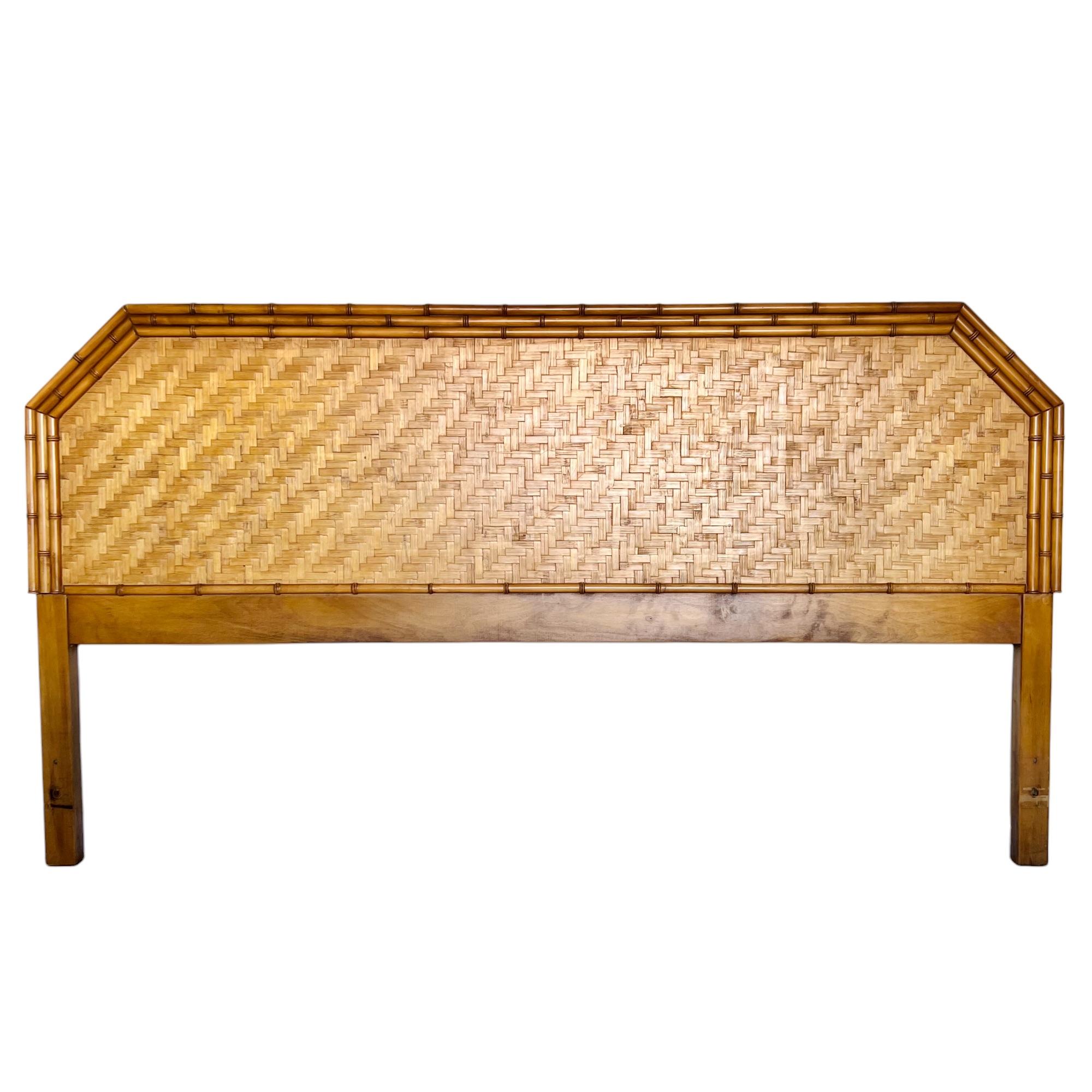 A vintage Palm Beach regency style low king headboard by Dixie Furniture, circa 1965. It features a woven split reed rattan parquetry panel and triple row faux bamboo turned wood framing. 

Dimensions: 80.5